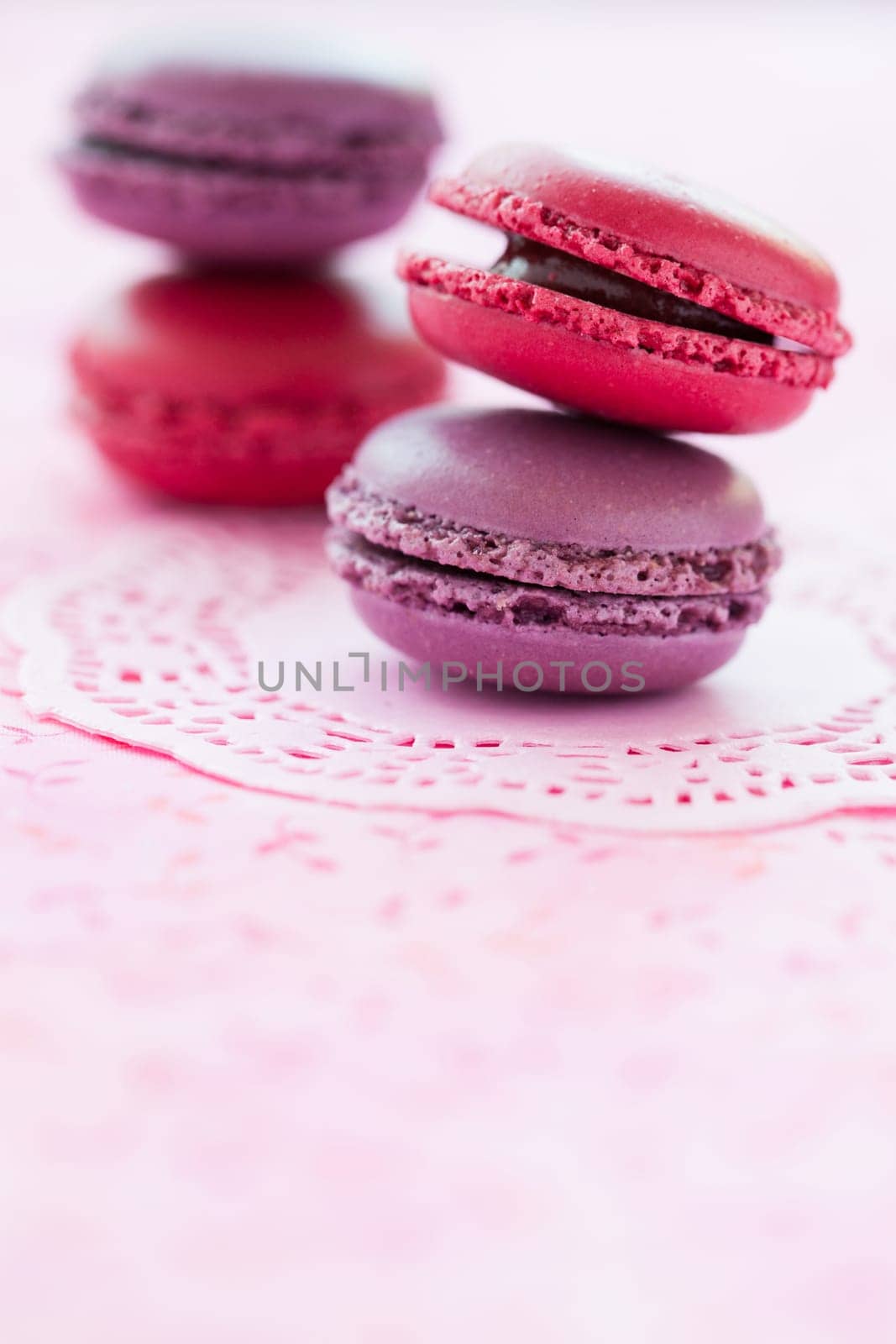 Closeup of two stacks of sweet macaroons on pink mat
