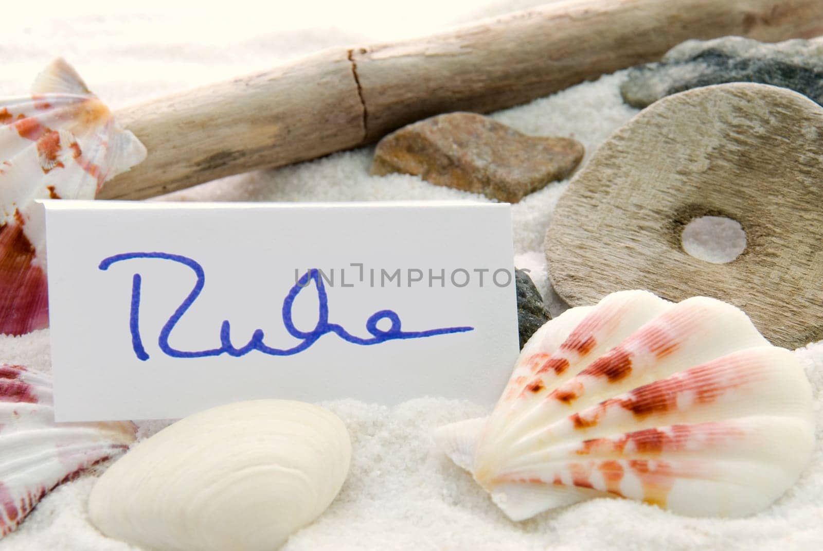 a beach and recreation background with a tag on which stands the german word Ruhe