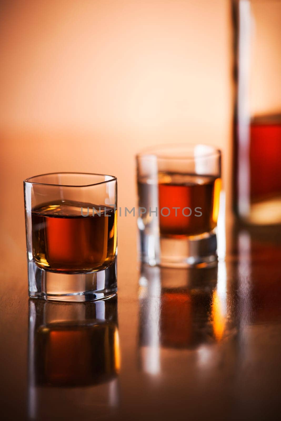 Glass of fine whiskey on counter close up