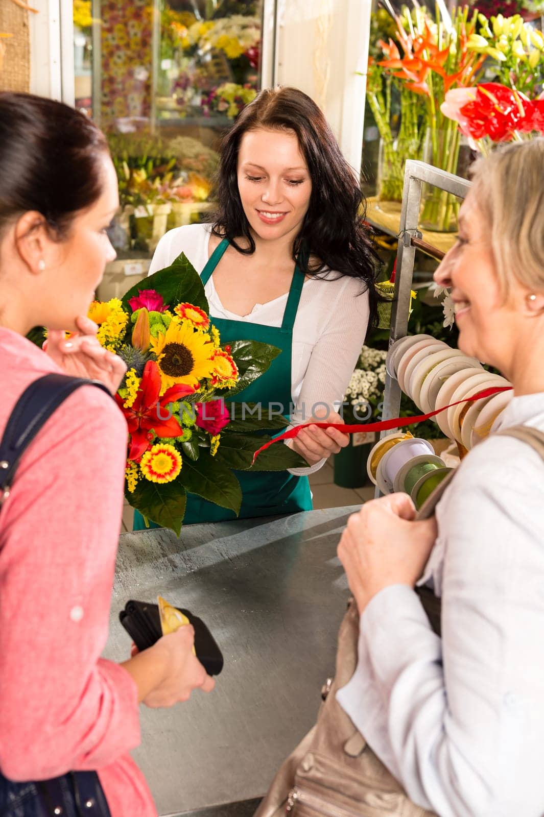 Happy women customers buying flowers sunflower bouquet shop florist