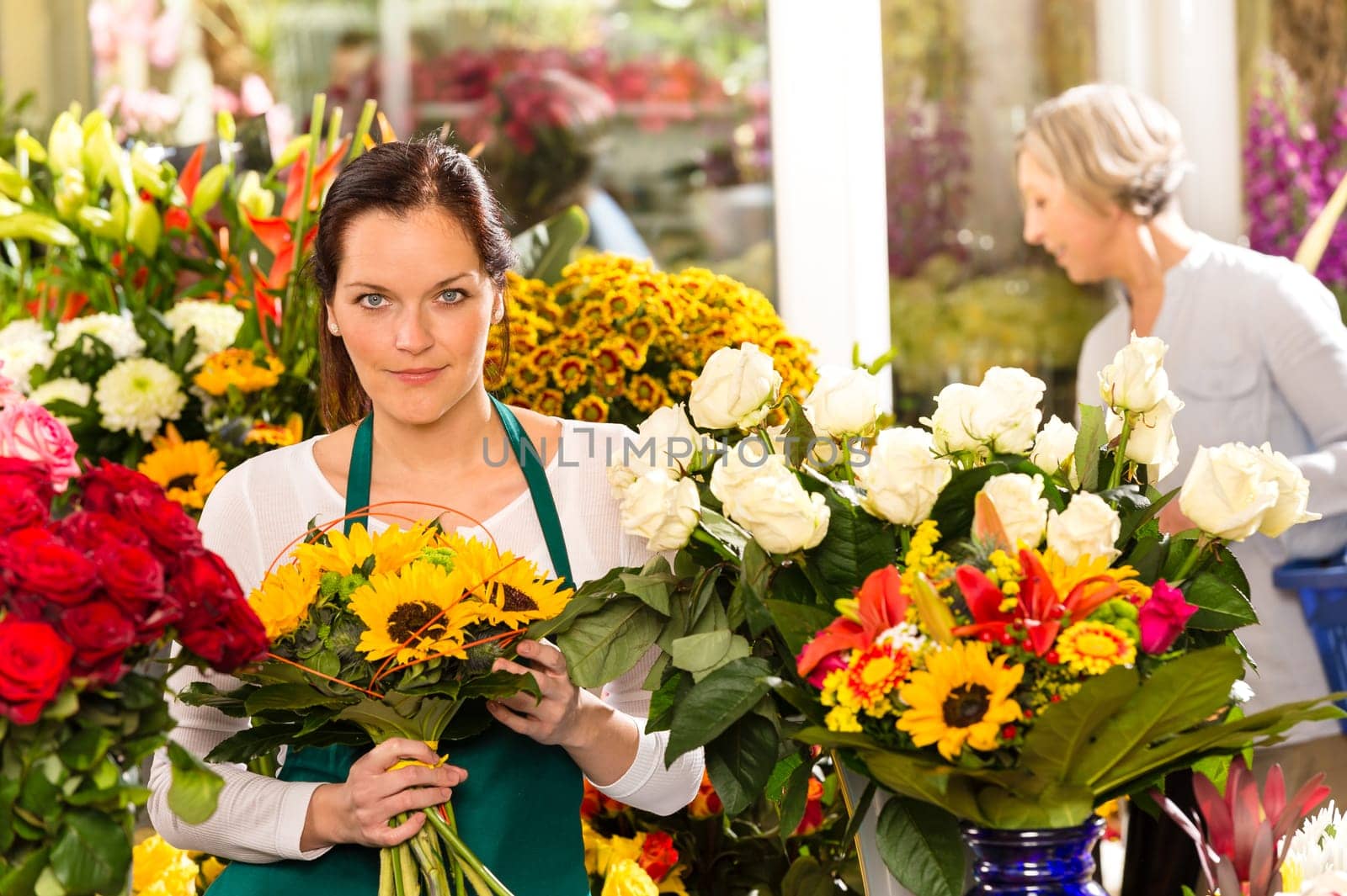 Woman florist selling sunflowers bouquet flower shop market buying