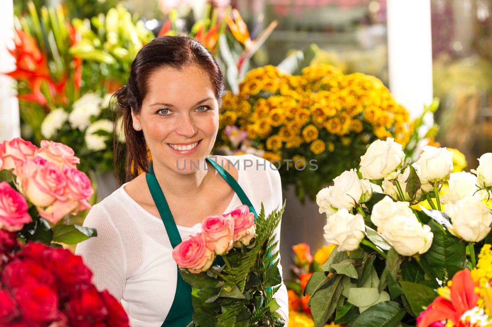 Smiling florist flower shop colorful making bouquet roses market