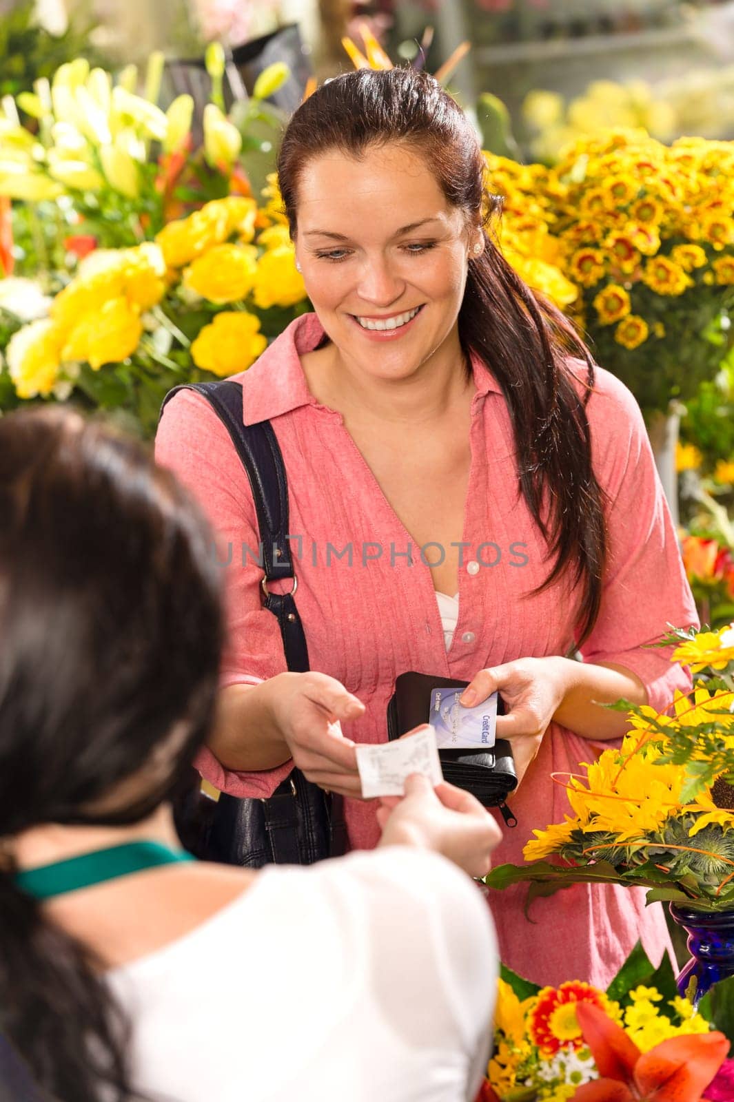 Woman customer taking receipt flower shop buying credit card