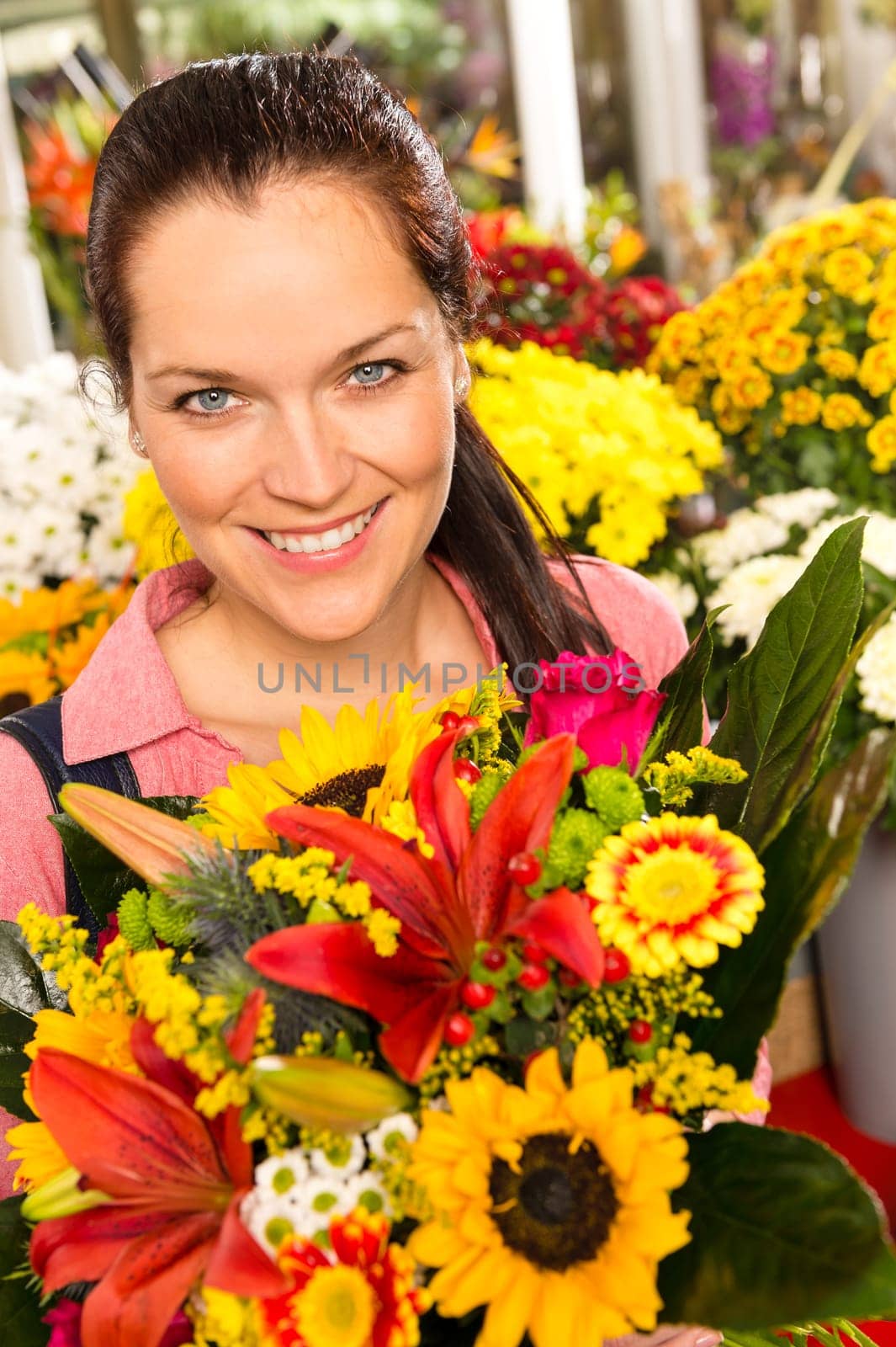 Smiling florist woman colorful bouquet flower market showing sunflower