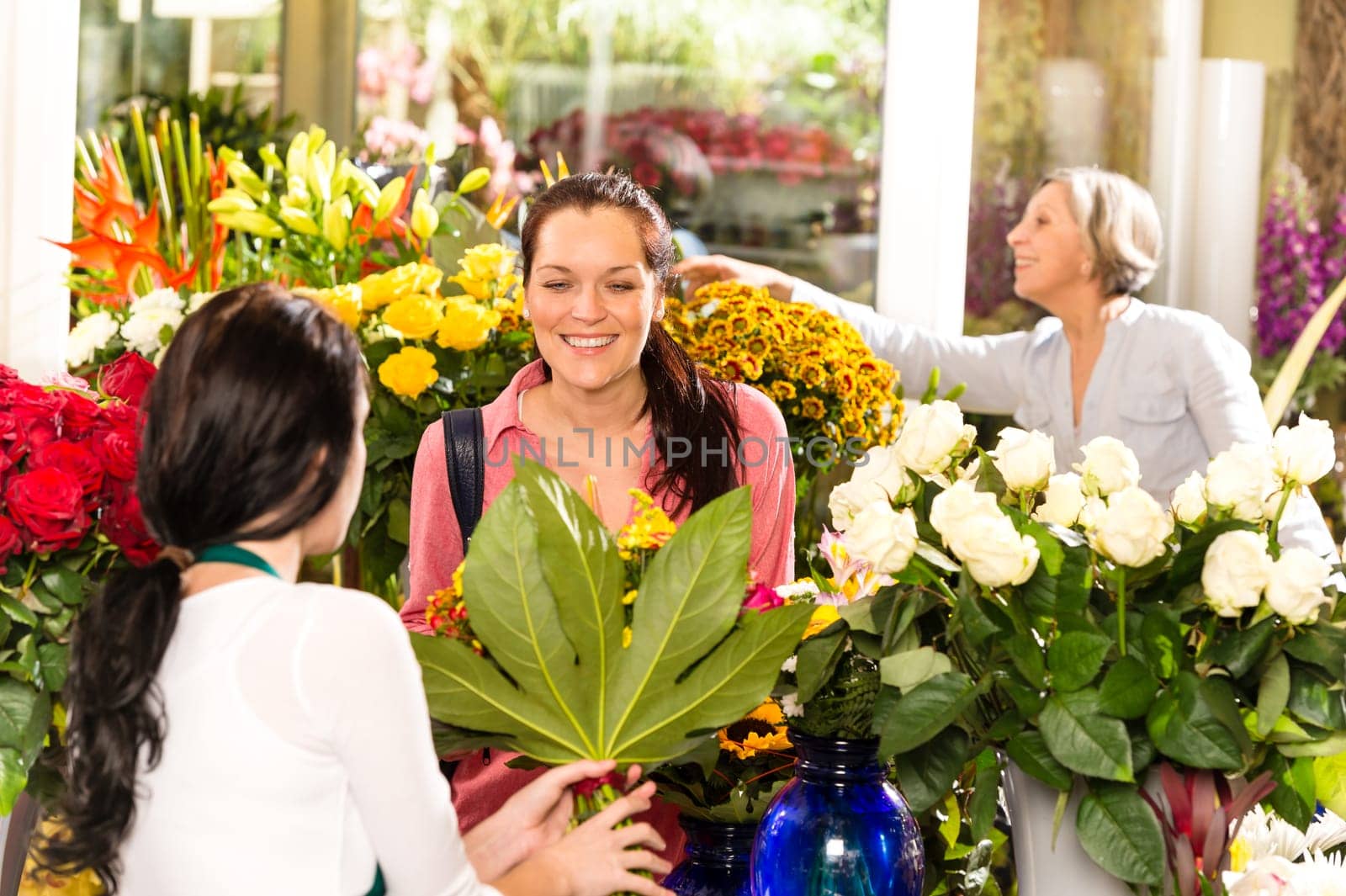 Young woman buying bouquet flower shop colorful customer