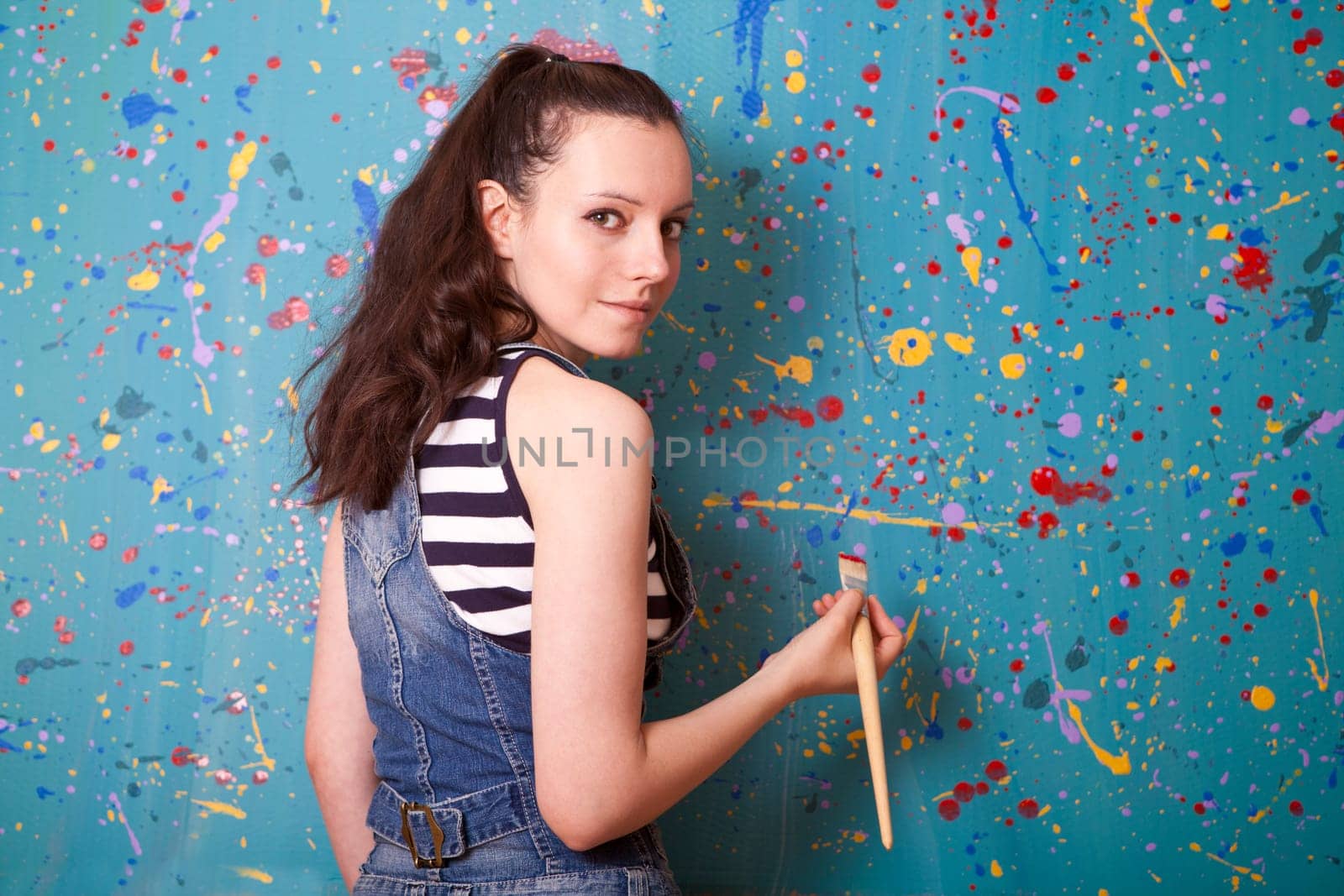 woman holding up a paintbrush