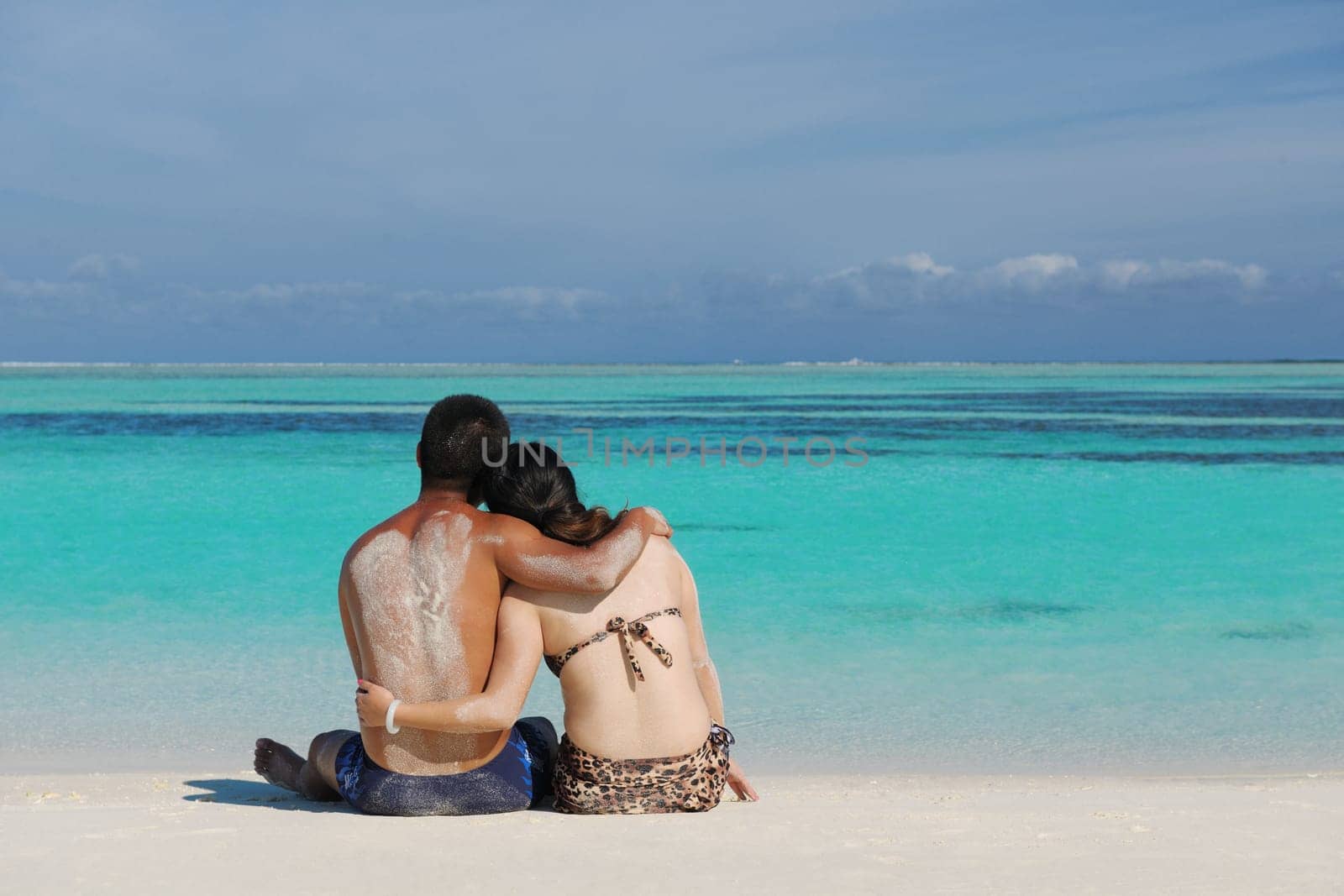 happy young asian couple enjoying summer and have on beautiful white sand beach