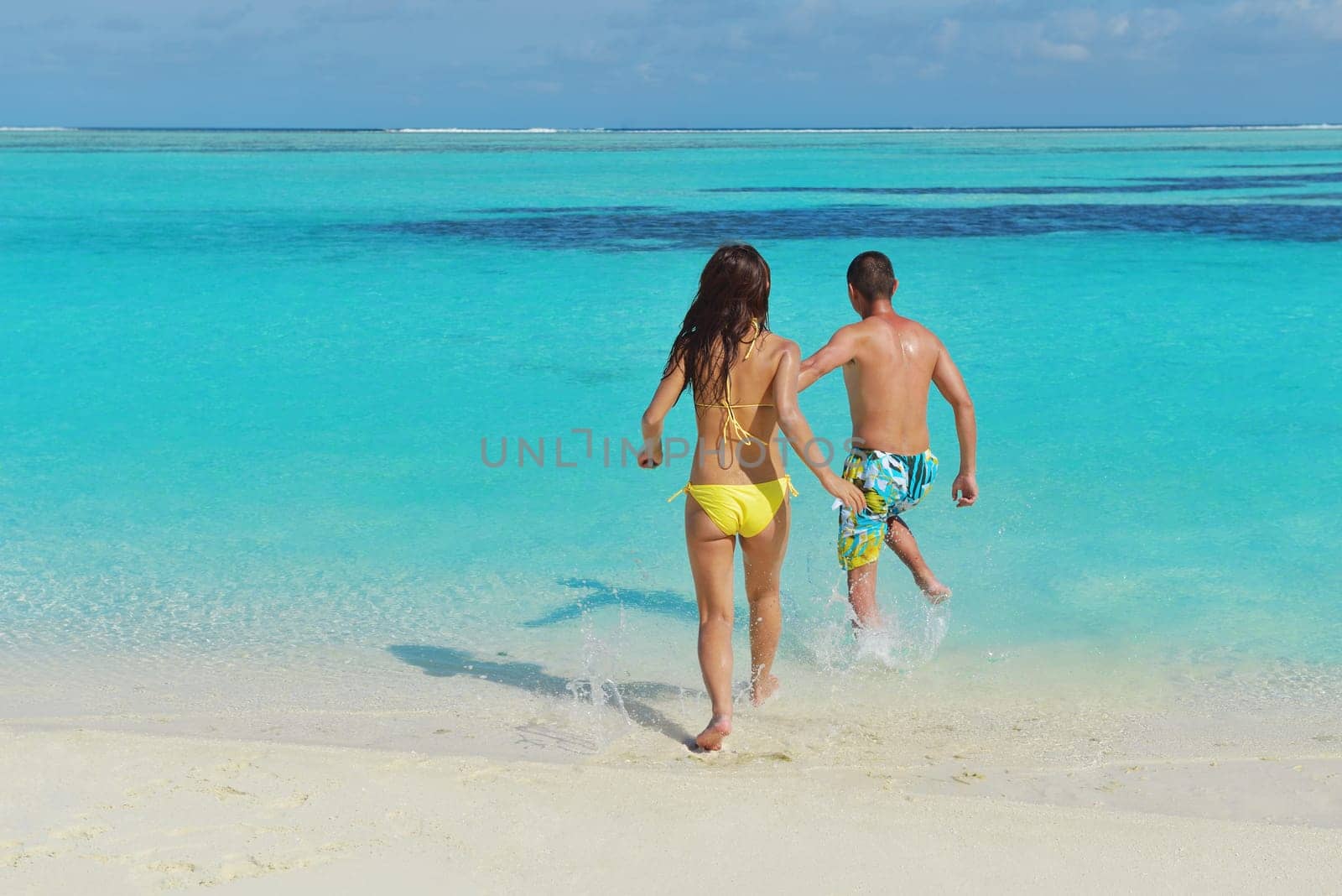 happy young asian couple enjoying summer and have on beautiful white sand beach
