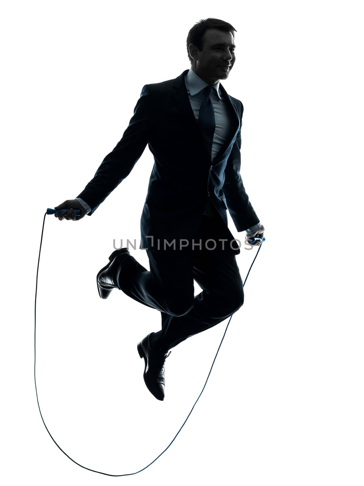 one caucasian businessman exercising jumping rope in silhouette studio isolated on white background