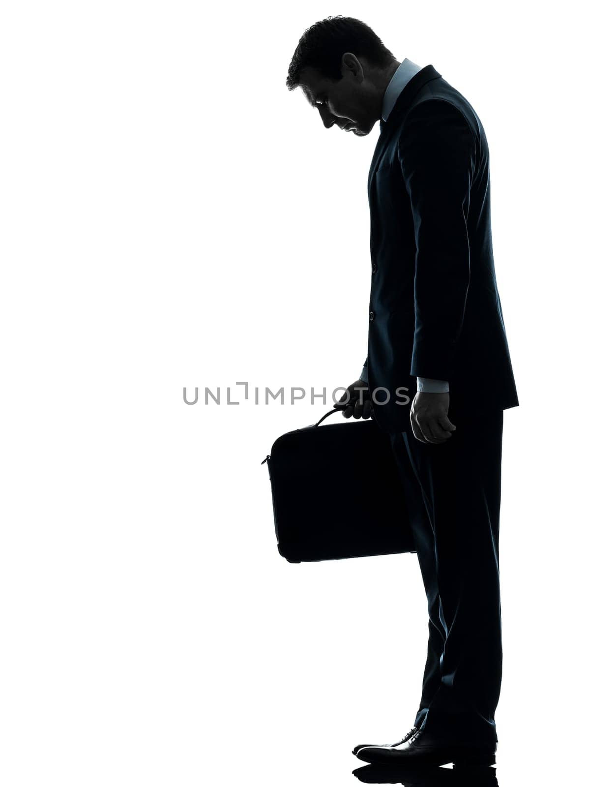 one caucasian sad business man  looking down  in silhouette studio isolated on white background