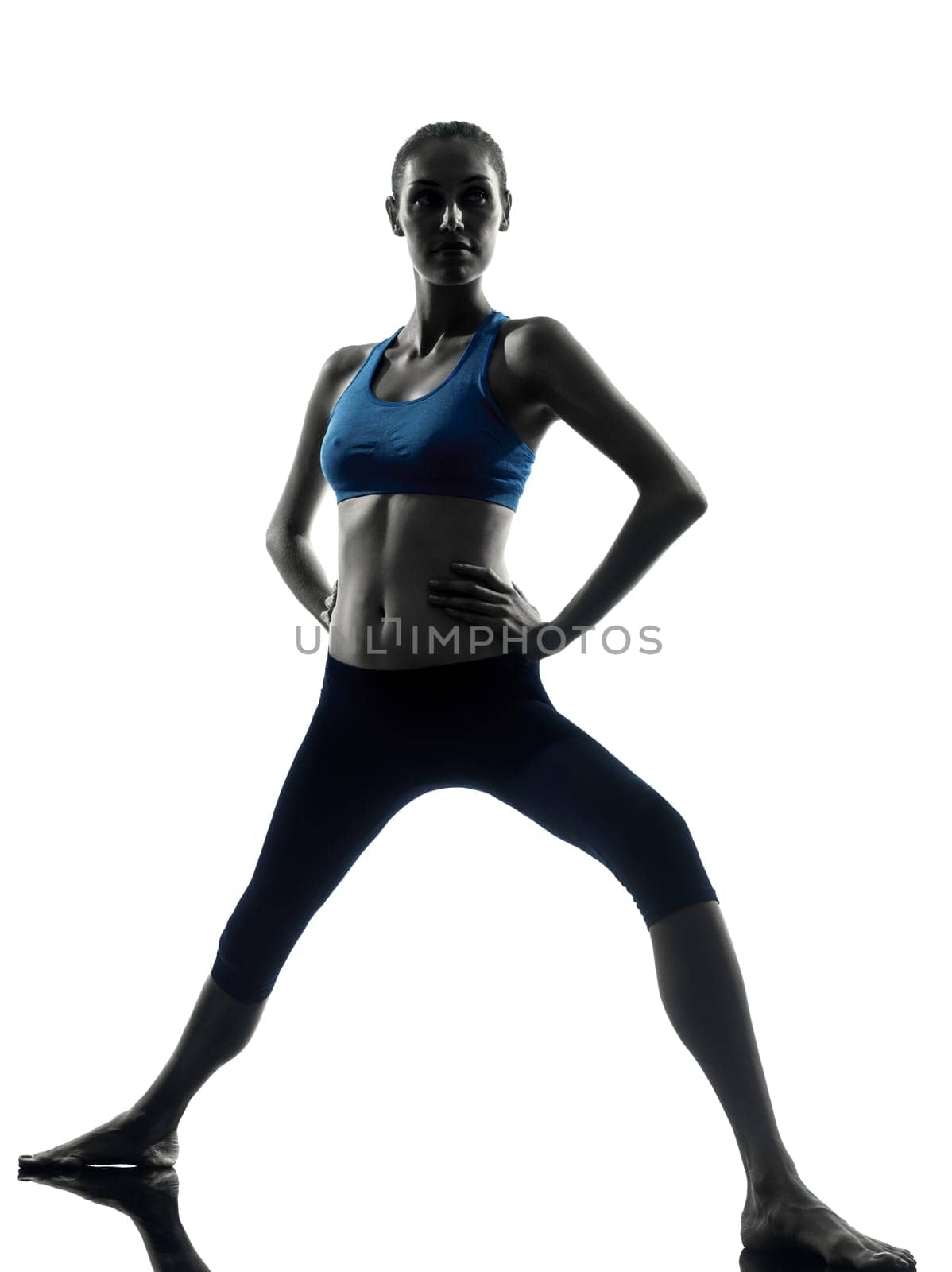one caucasian woman exercising yoga warrior position in silhouette studio isolated on white background