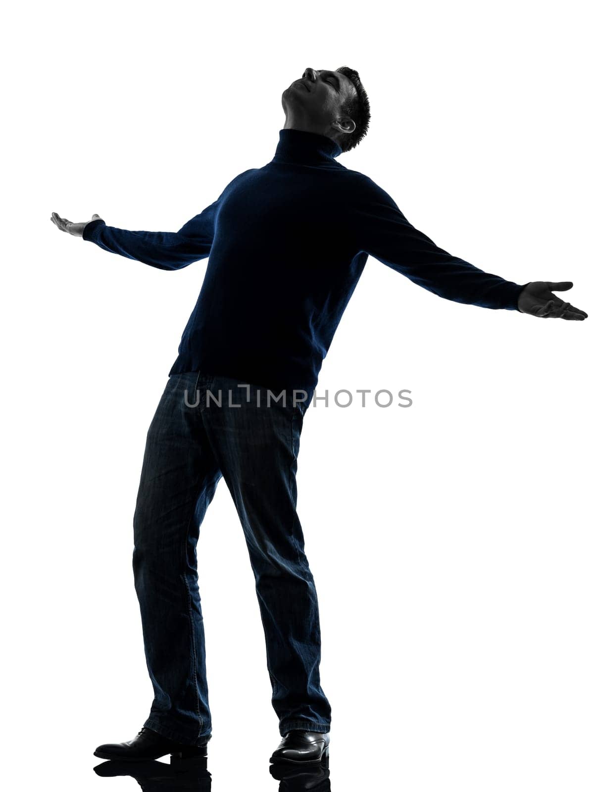 one caucasian happy man looking up full length in silhouette studio isolated on white background