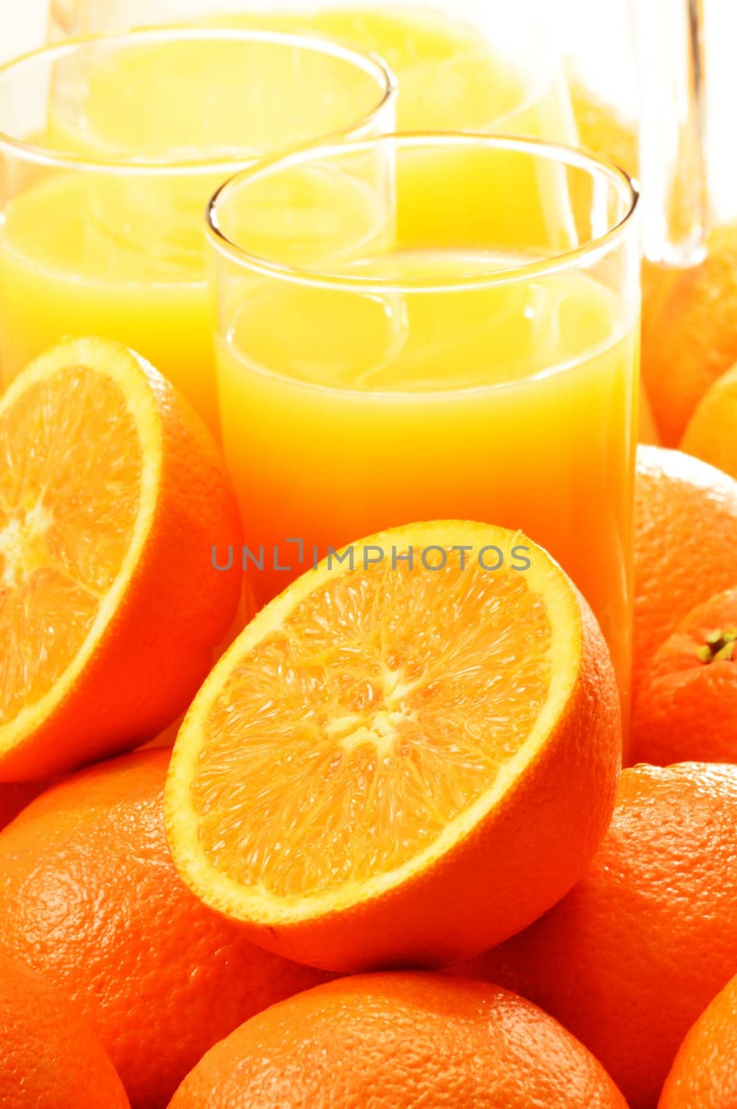 Composition with two glasses of orange juice and fruits