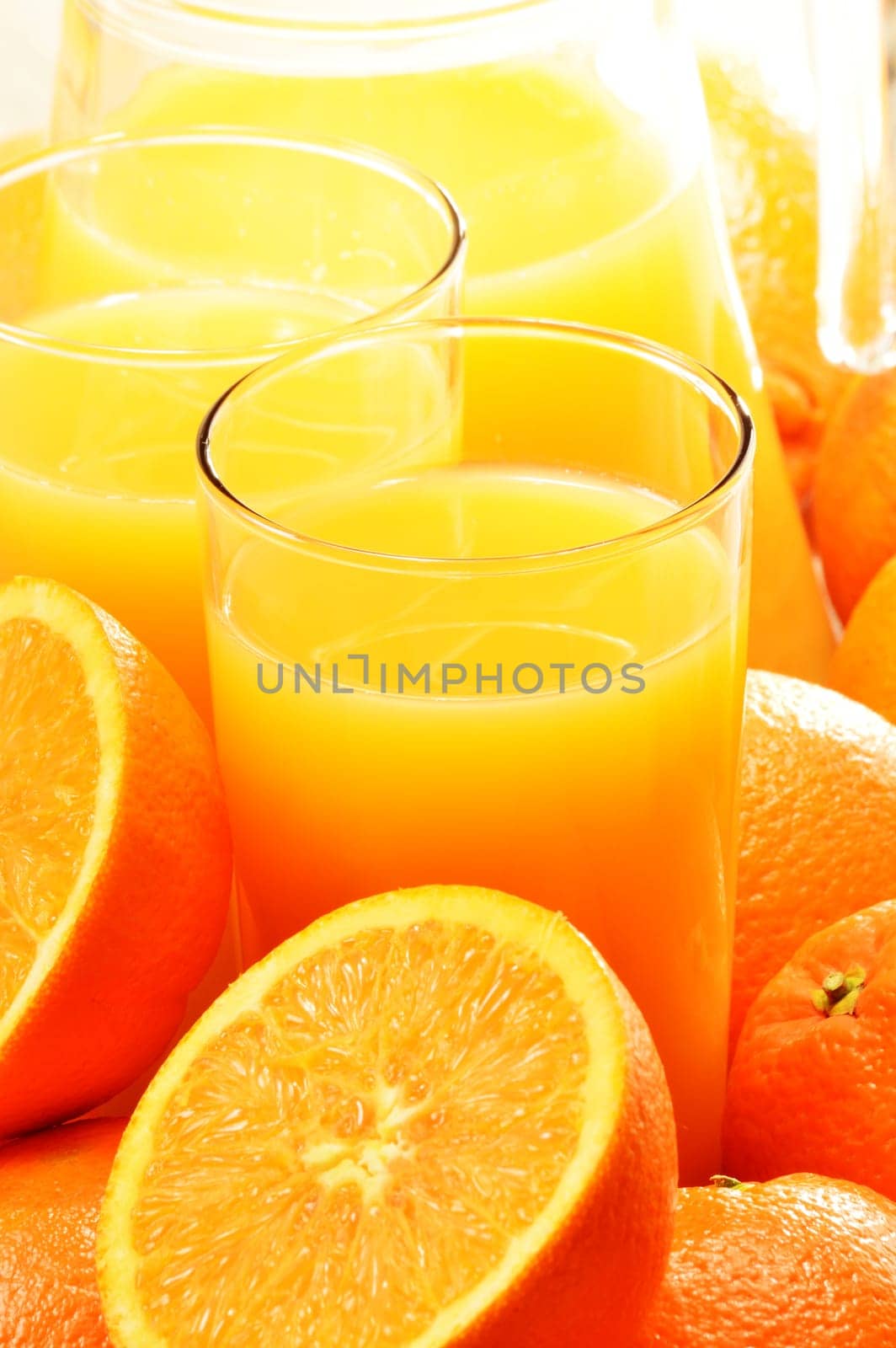 Composition with two glasses of orange juice and fruits