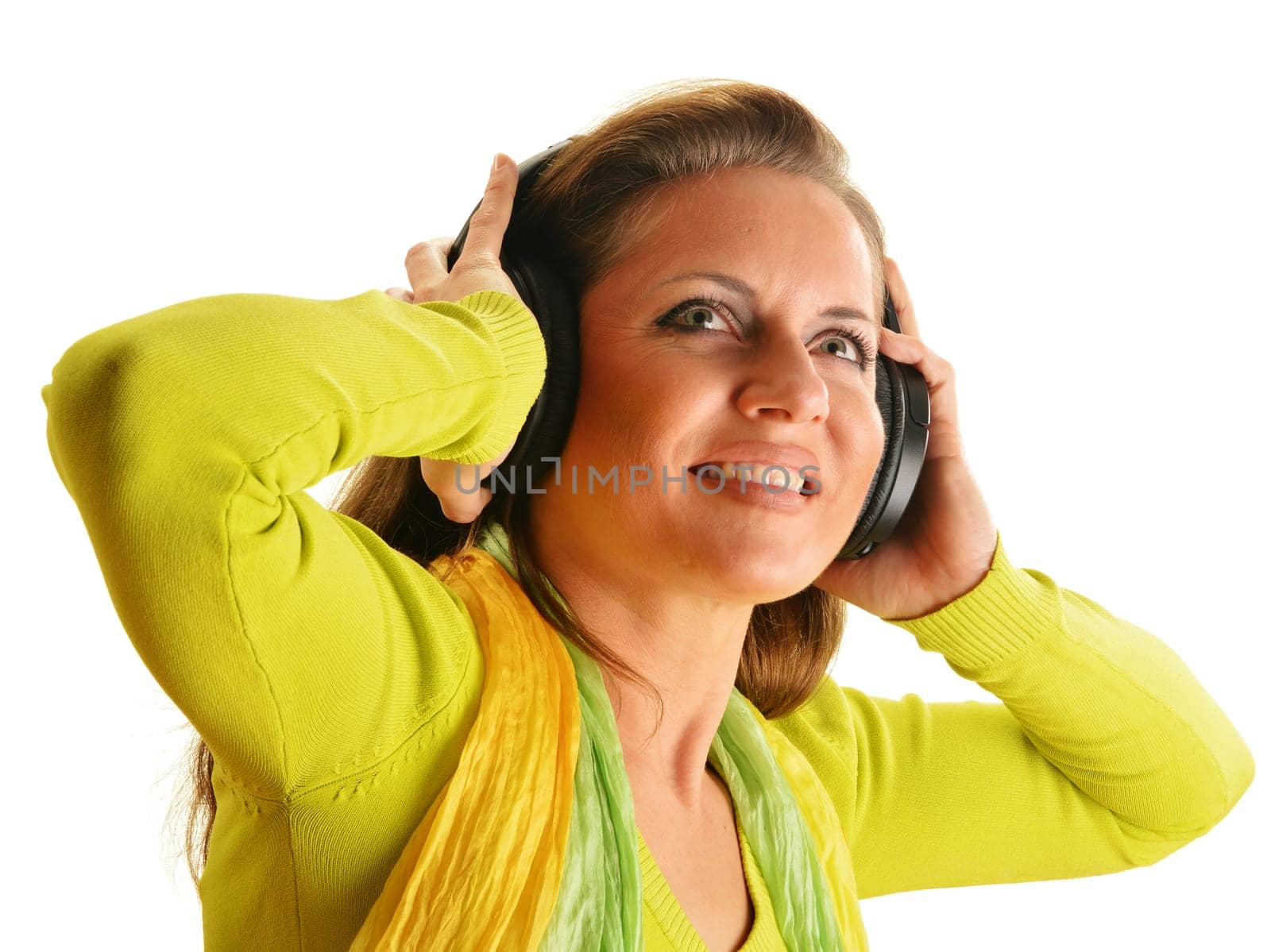 Happy young woman listening to the music in headphones isolated on white background