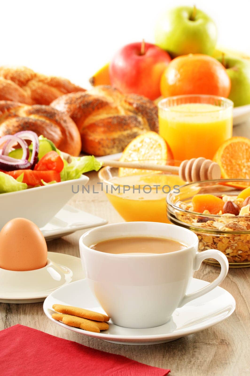 Breakfast including coffee, bread, honey, orange juice, muesli and fruits