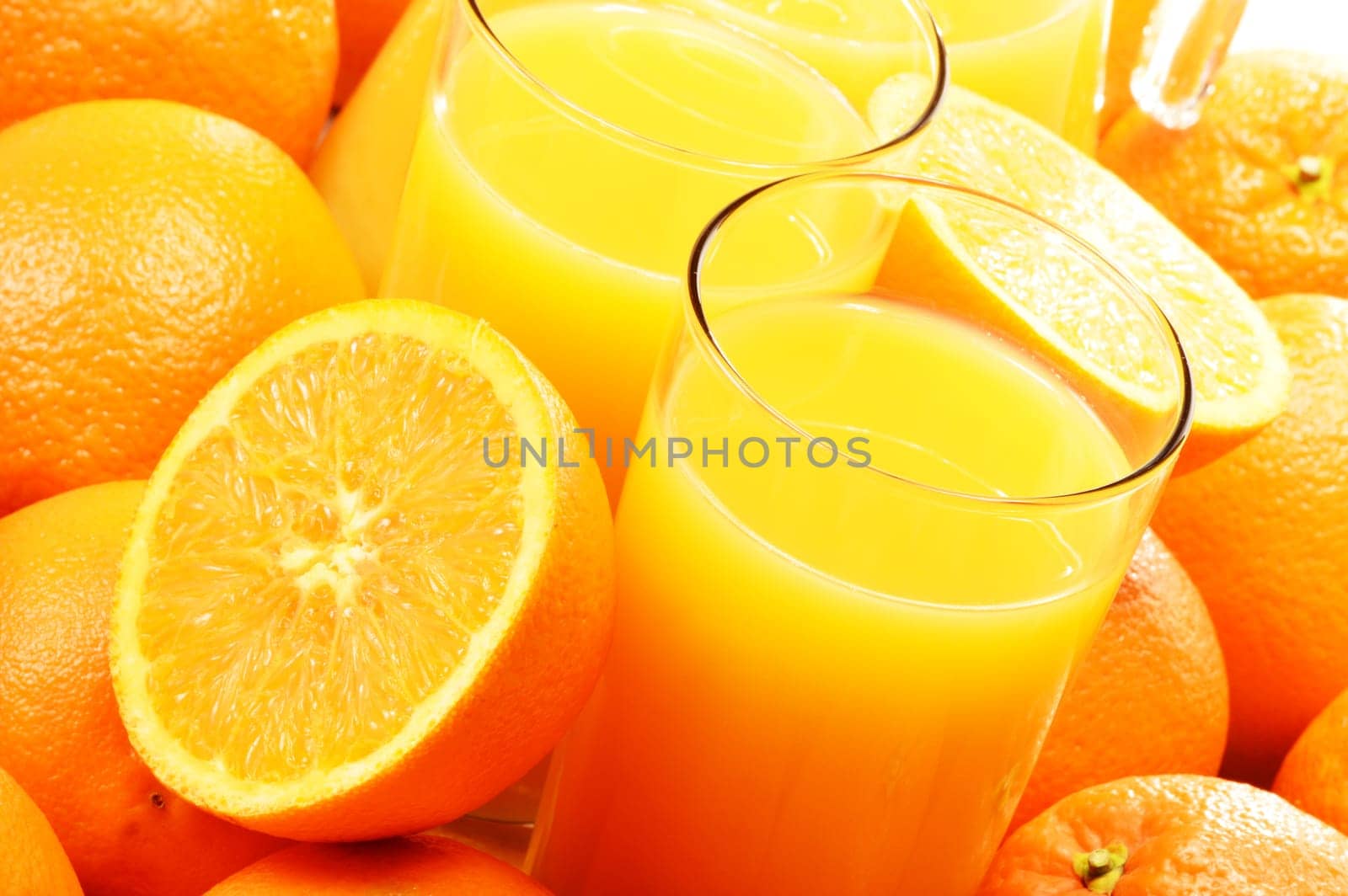 Composition with two glasses of orange juice and fruits