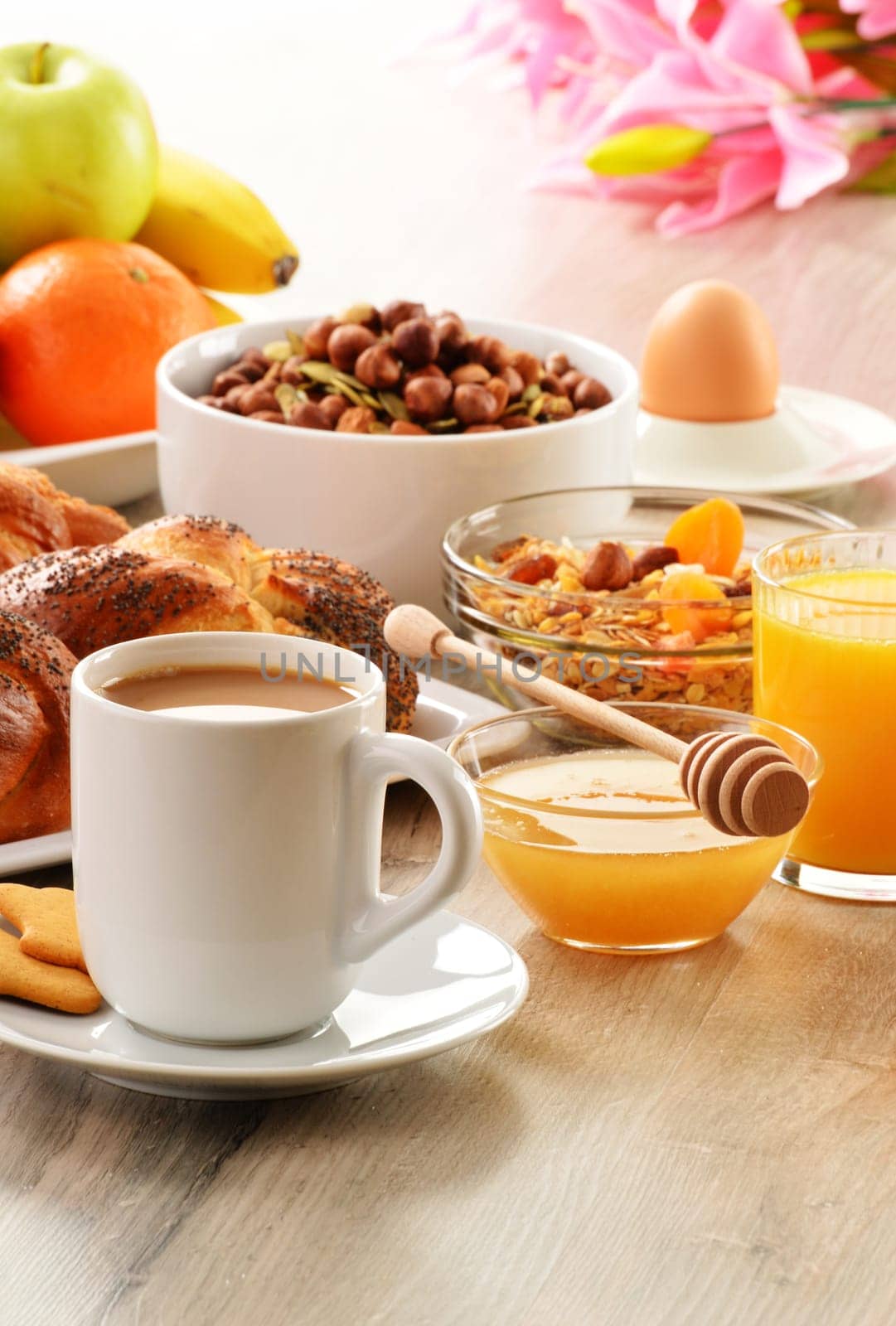 Breakfast including coffee, bread, honey, orange juice, muesli and fruits