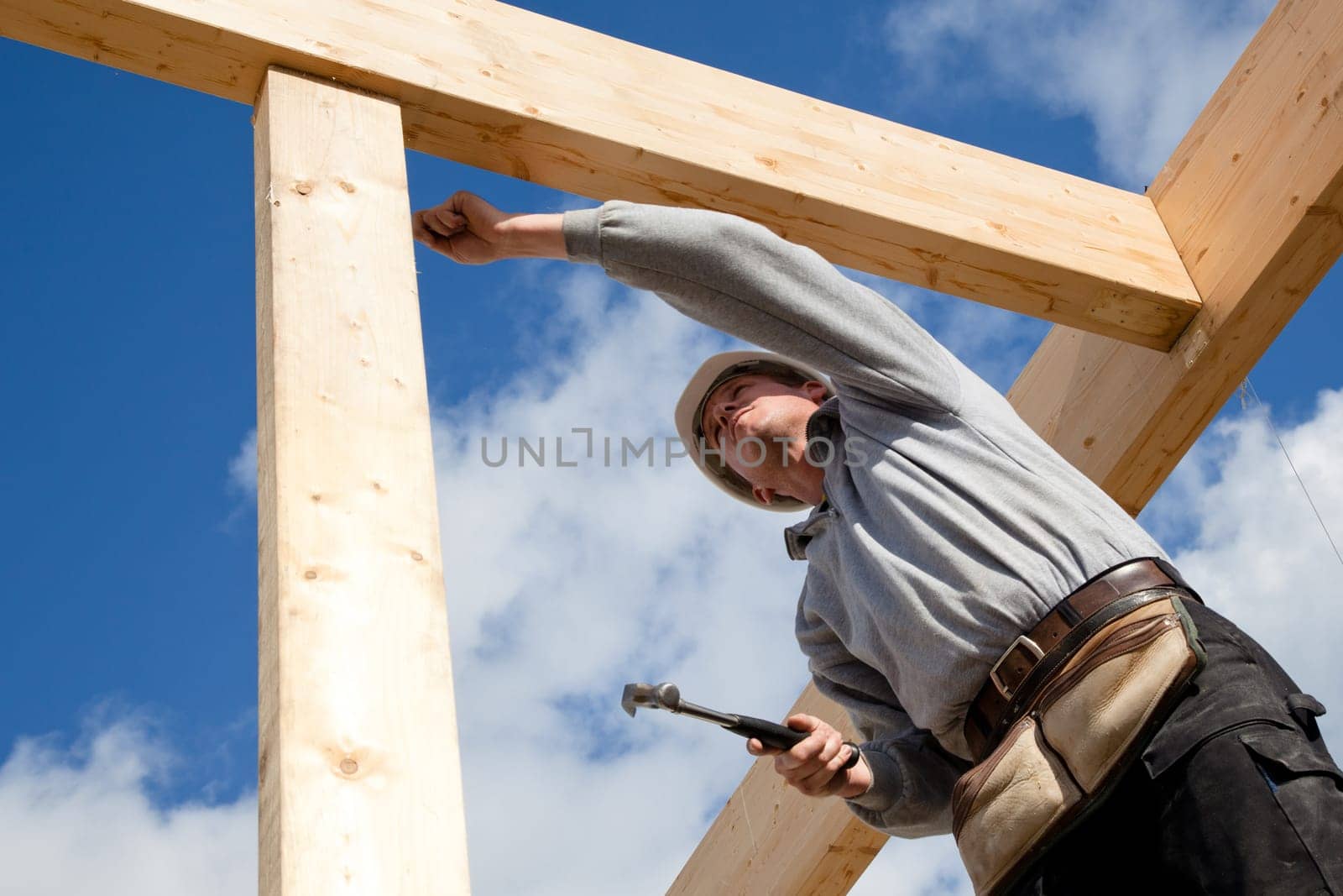 carpenter at work with wooden  roof construction