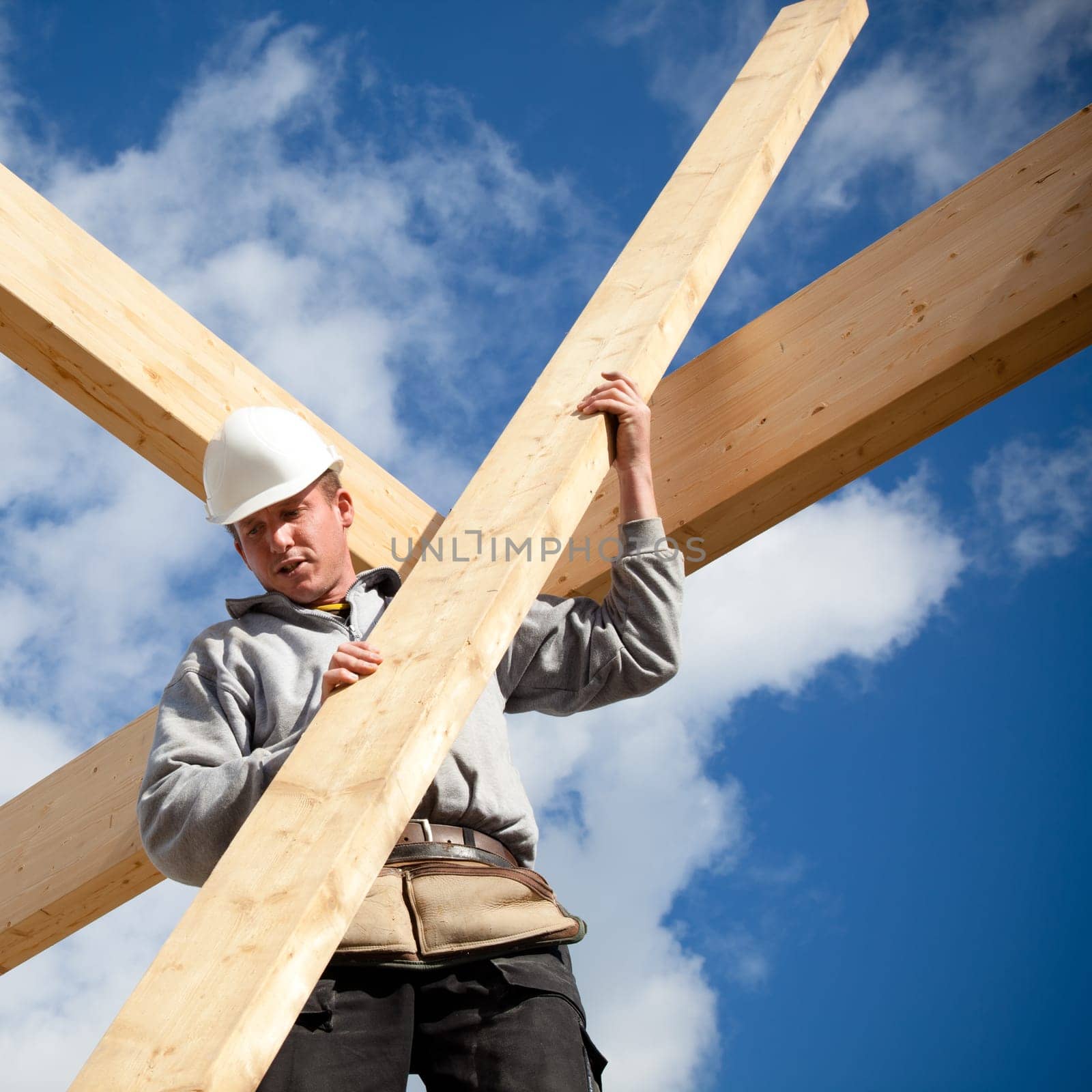 carpenter at work with wooden  roof construction
