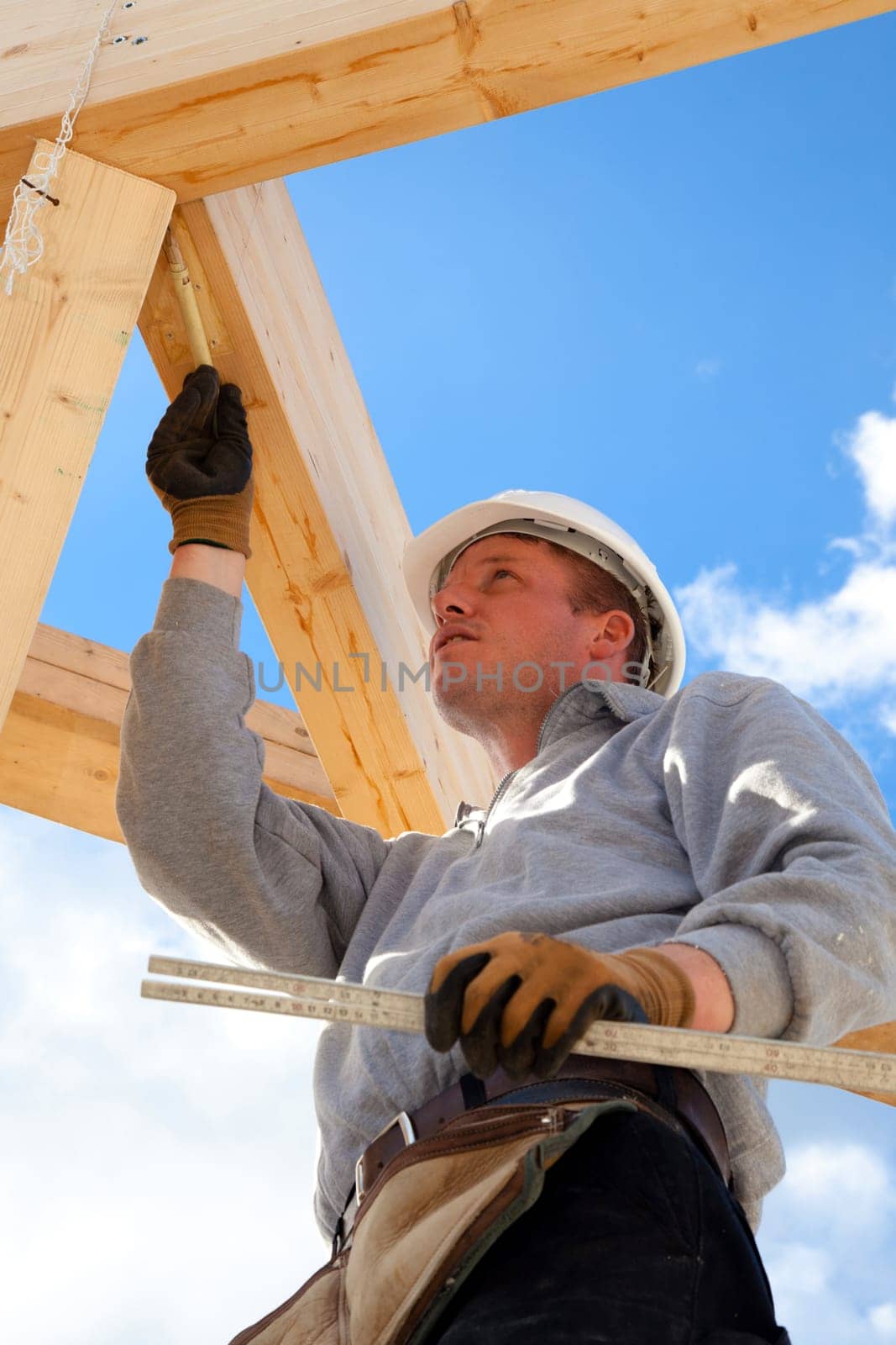 carpenter at work with wooden  roof construction