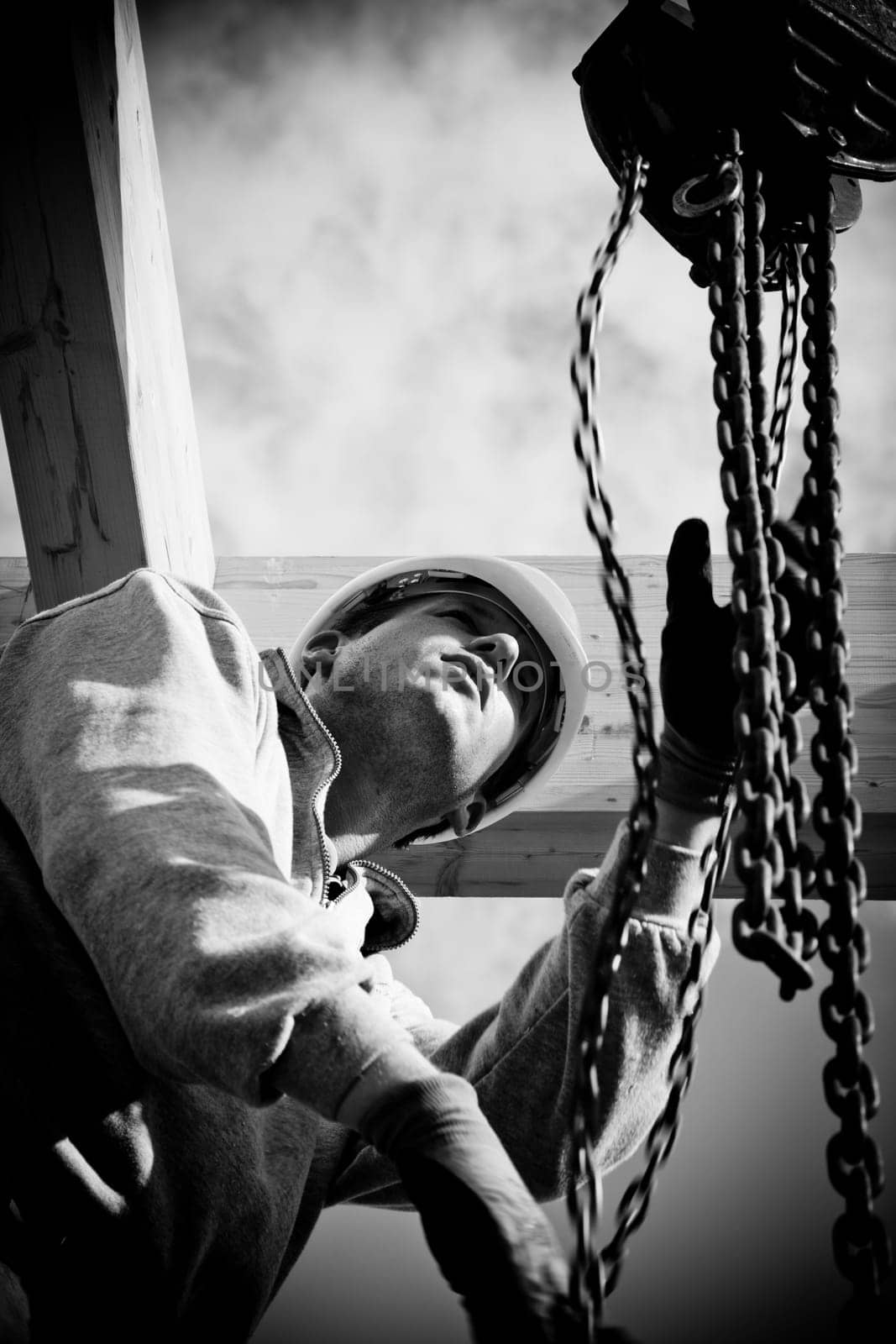 carpenter at work with wooden  roof construction