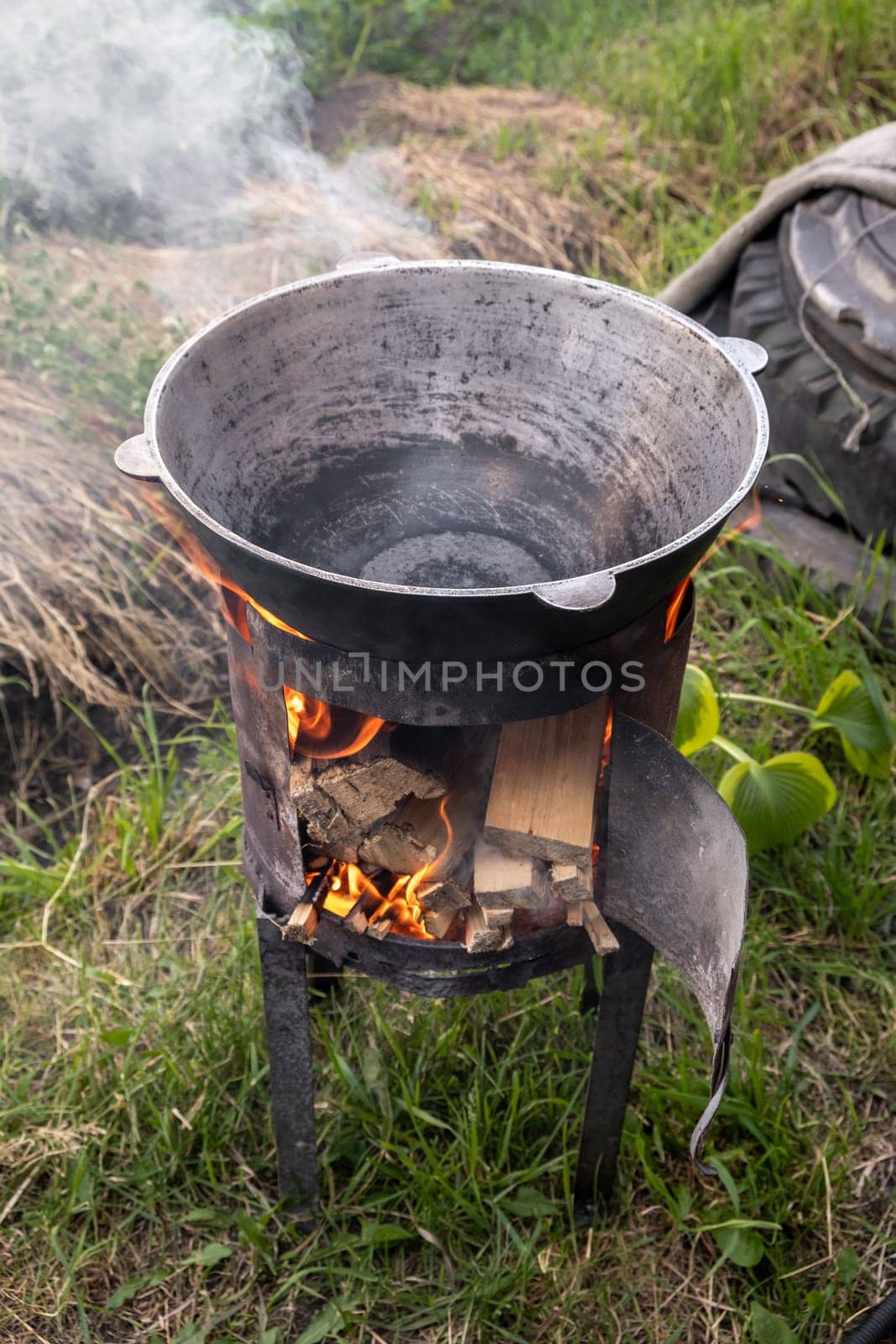 Cooking in cauldron on open fire in nature. by AnatoliiFoto