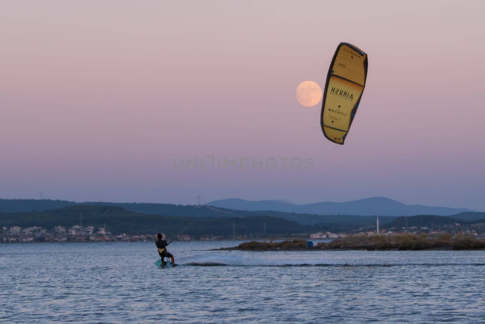 Gulbahce,Urla,Izmir,Turkey - July 30, 2023, People kite surf at the beach on a sunny afternoon in Gulbahce , Urla Izmir. by senkaya