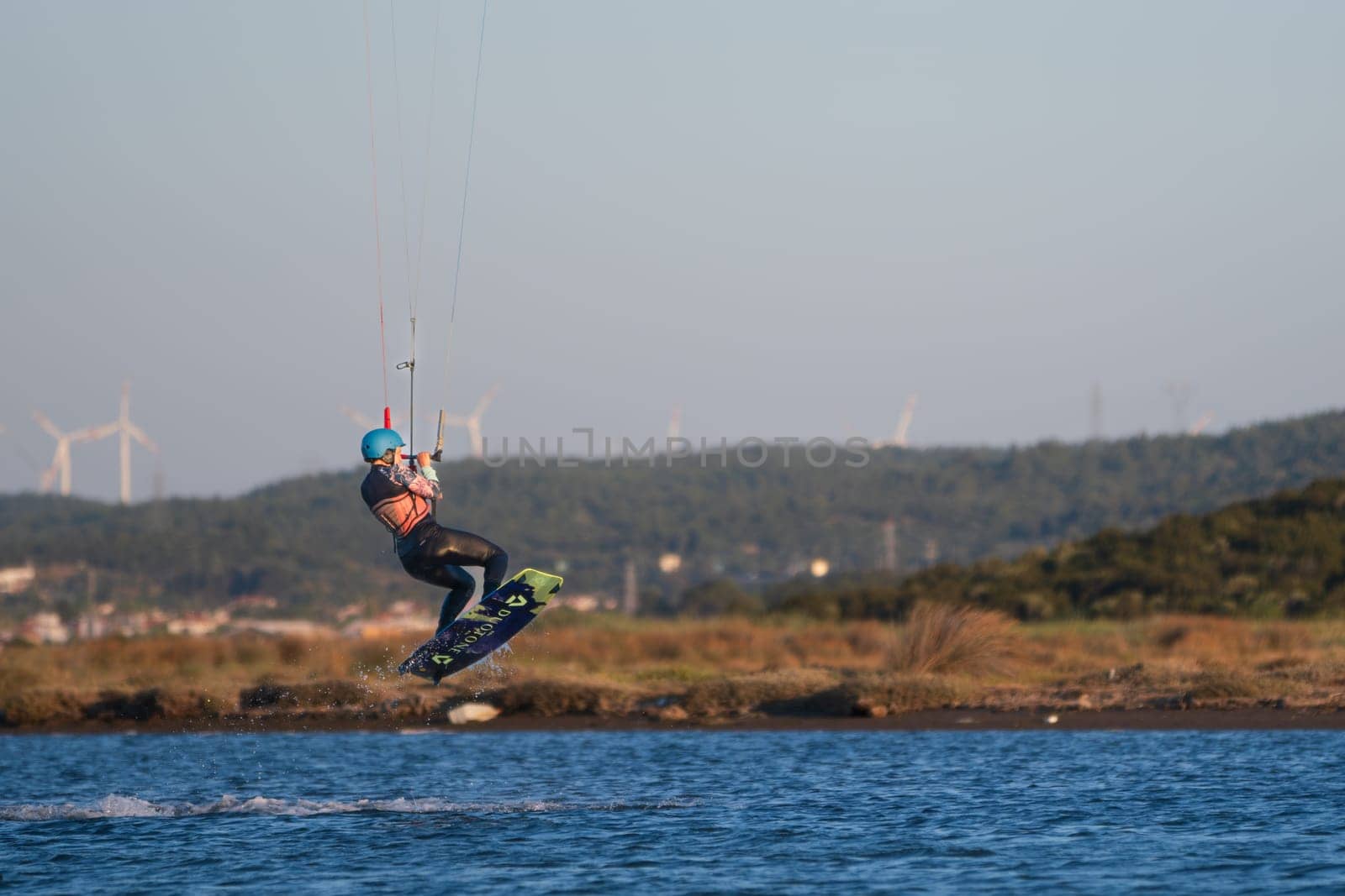 Gulbahce,Urla,Izmir,Turkey - July 30, 2023, People kite surf at the beach on a sunny afternoon in Gulbahce , Urla Izmir. by senkaya