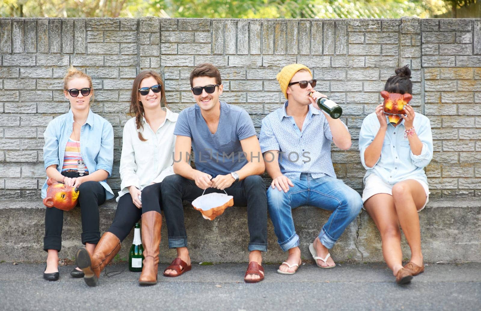 Social, portrait and friends on a bench in public for drinks, conversation and bonding on the weekend. Happy, group and people in the city for alcohol, communication and together for society by YuriArcurs