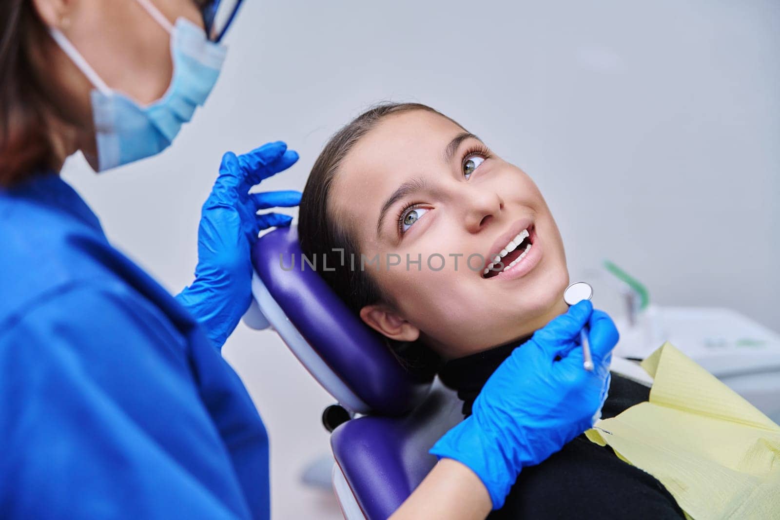 Young teenage female on dental examination treatment in clinic by VH-studio