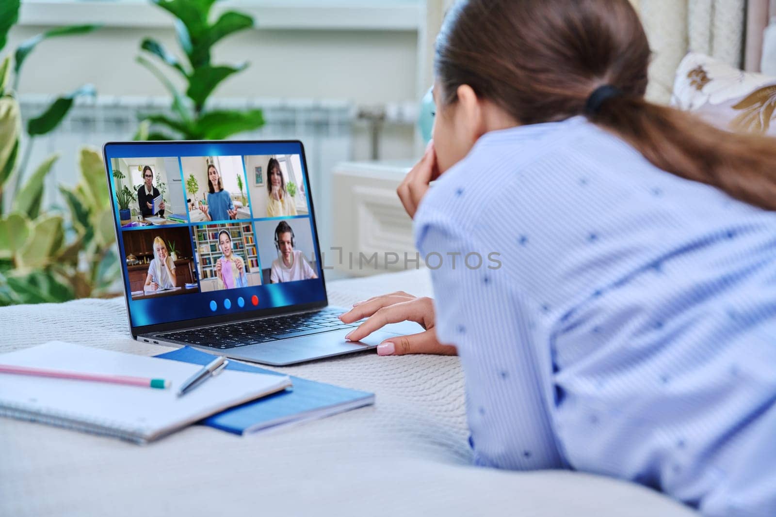 Video conference, teen girl student looking at laptop screen with group of teenagers studying remotely at home. Online lesson distance learning course. E-learning e-education technology high school