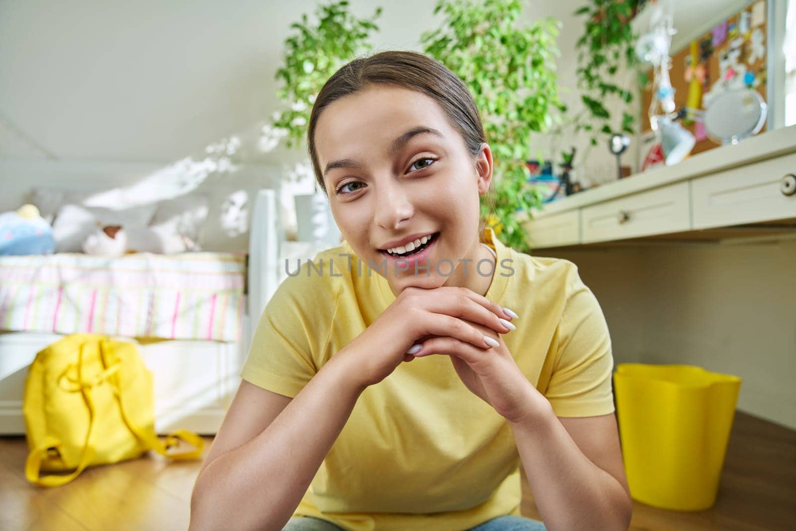 Teenage female student having video conference chat call. Talking female teenager looking at webcam. Young vlogger recording video content. Technology, telecommunications, adolescence, high school