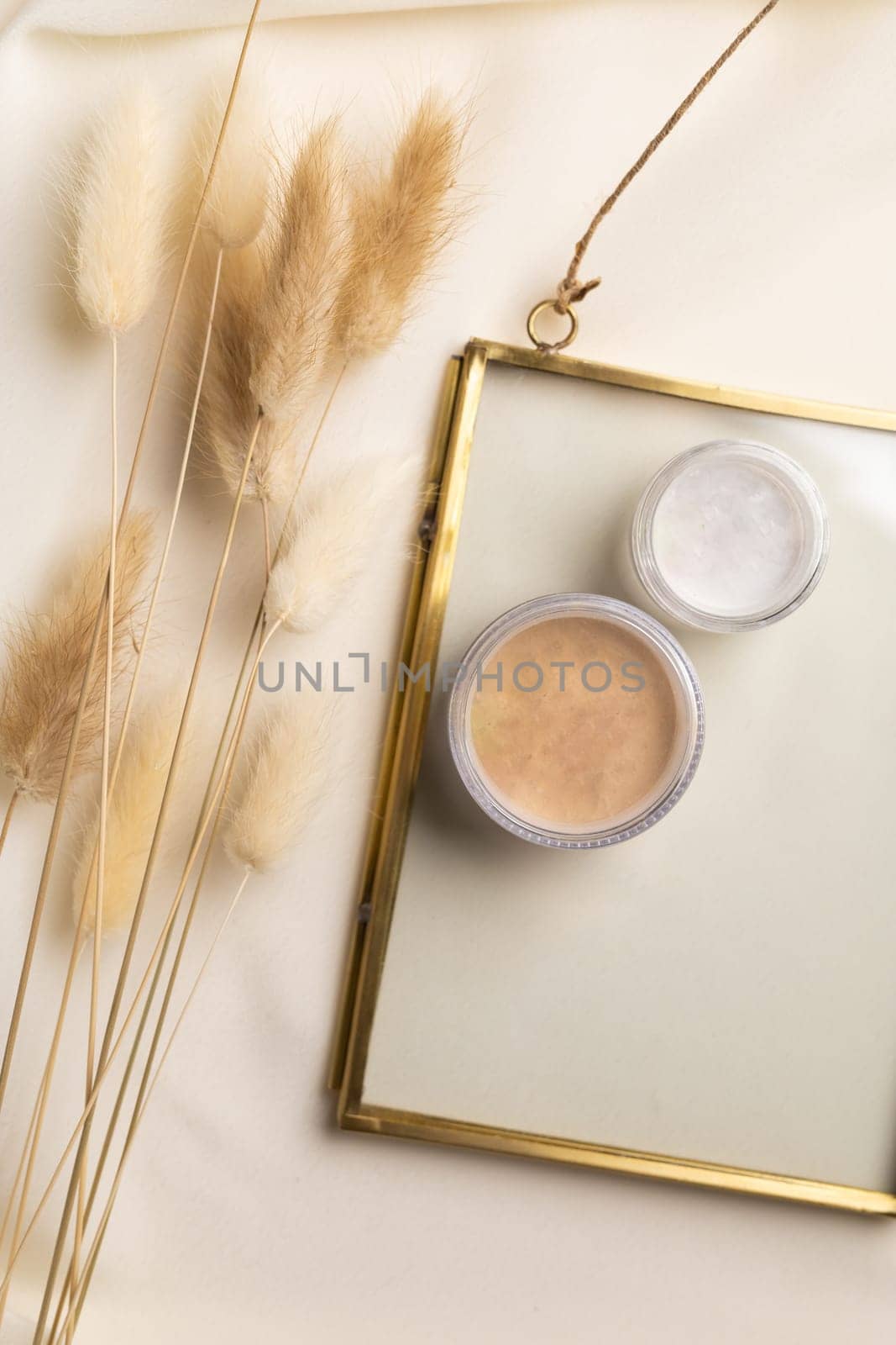 Top view facial powder on natural background with dried flowers. Aesthetics of makeup artist, make-up for yourself and beauty salon by Satura86