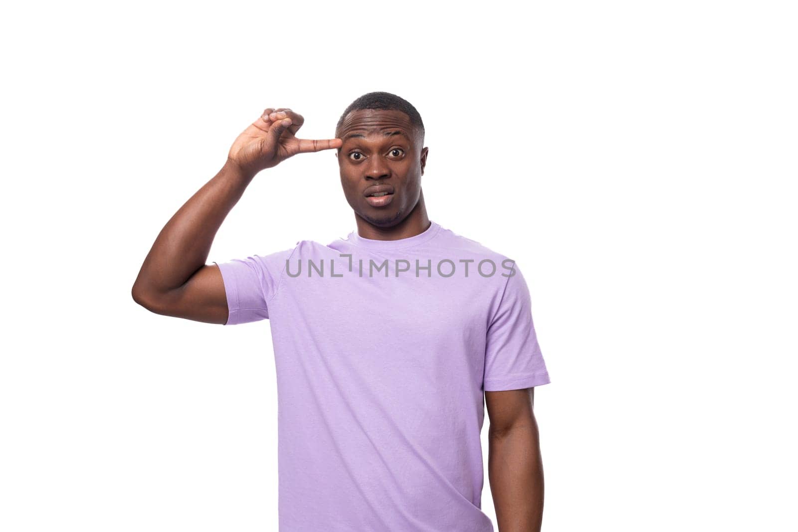 young handsome american man looks at the camera in surprise on a white background.