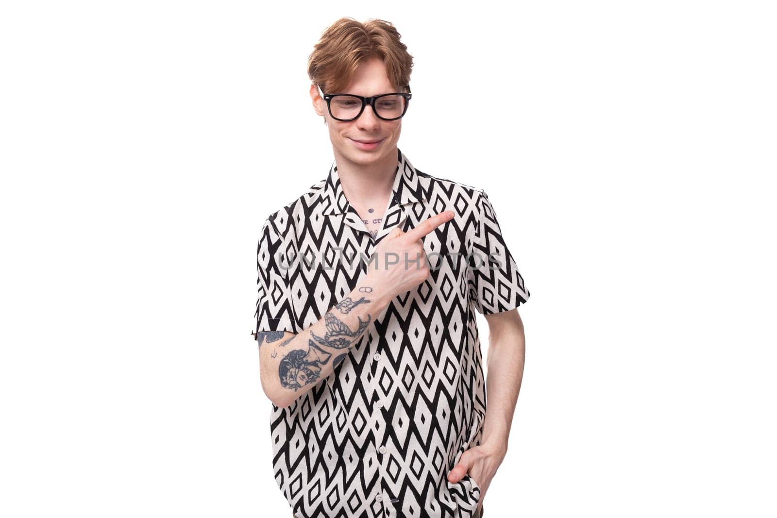 young surprised caucasian man with reddish golden hair in a black and white summer shirt is trying to remember something.