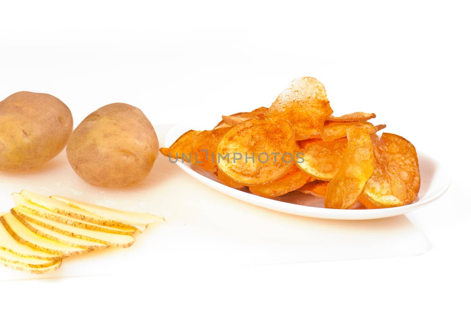 Potato chips,seasoned,on white plate