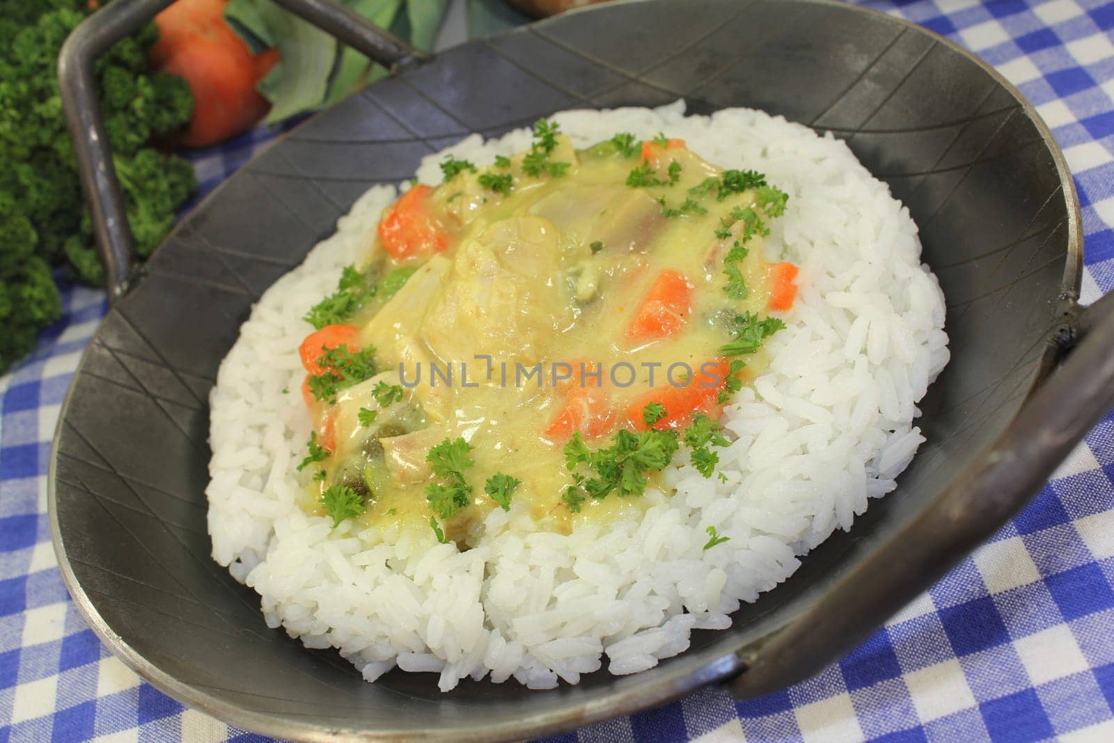 a pan with rice and colorful chicken fricassee