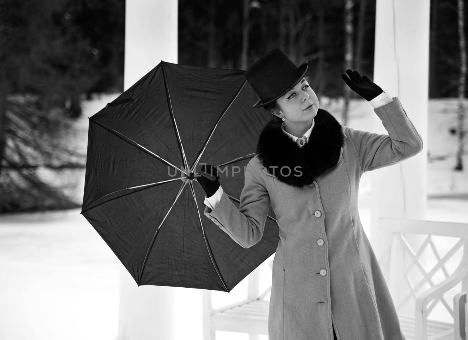 Shaded woman with umbrella feeling winter wind flow