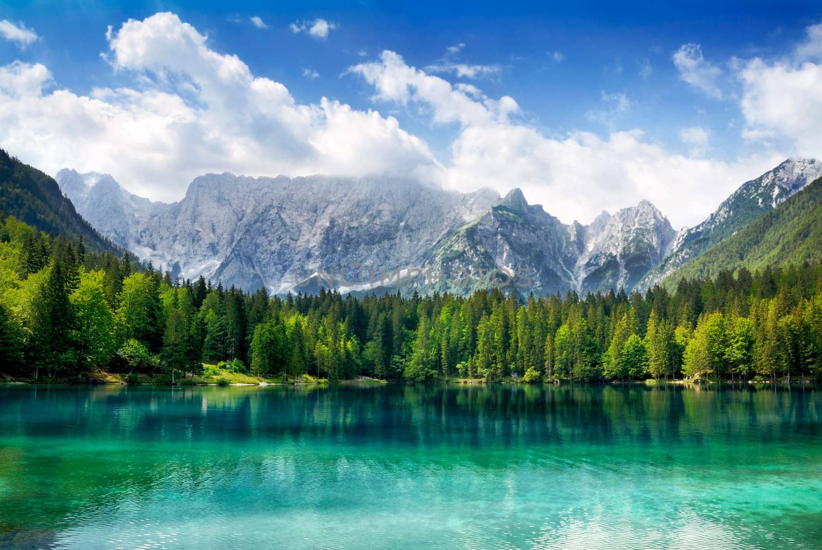 Beautiful landscape with turquoise lake,coniferous forest and mountains in the background