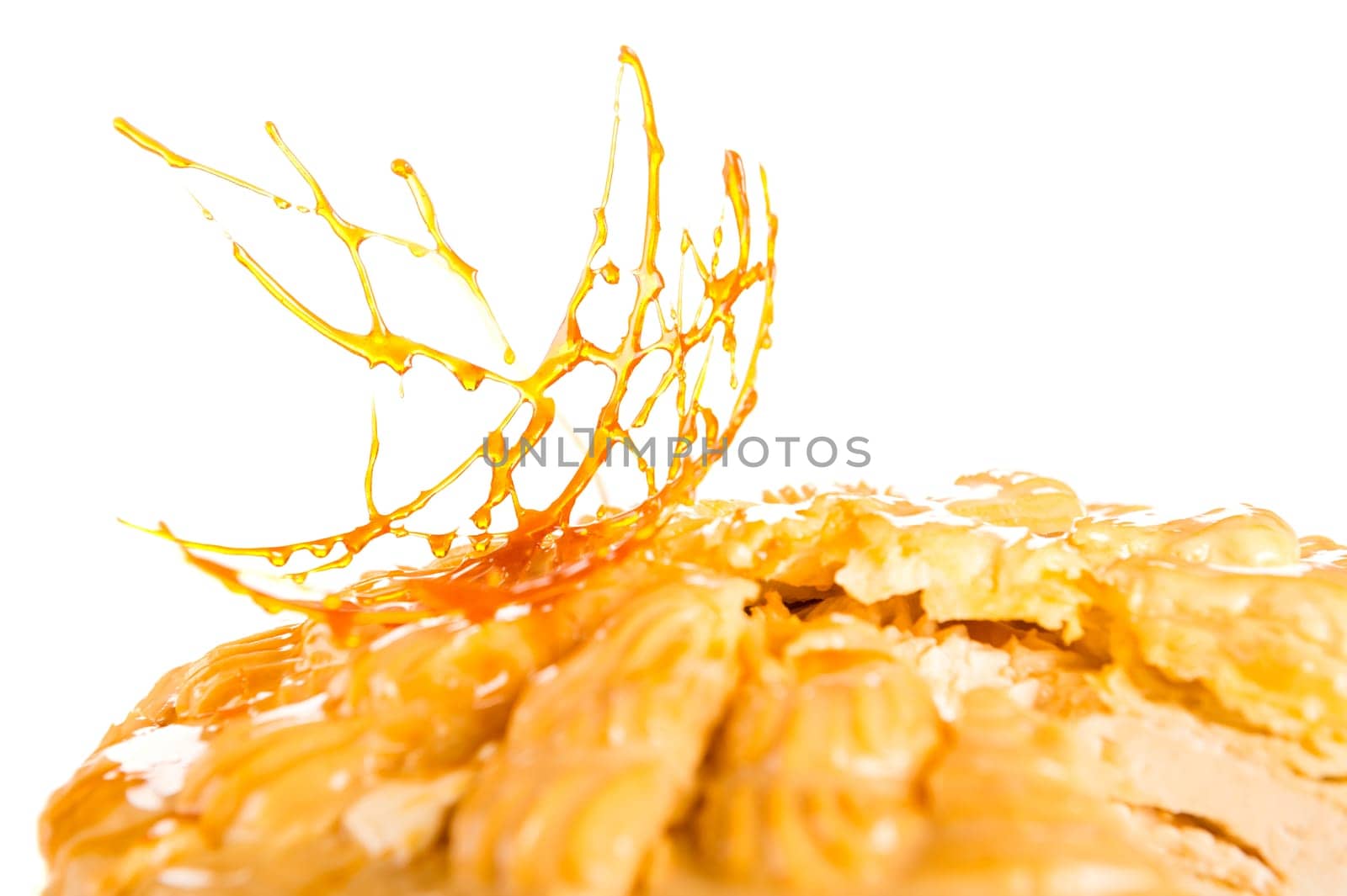 Delicious creamy dessert with caramel topping on isolated background