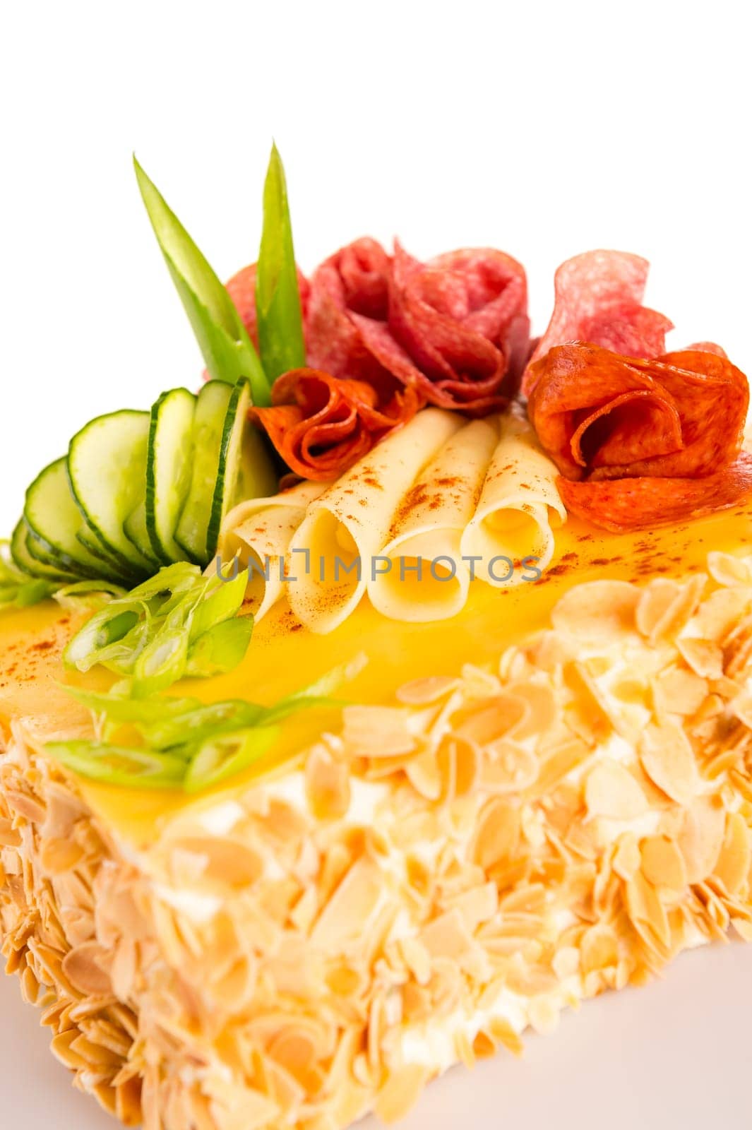 Salty pastry almond pie with cheese salami and cucumber topping