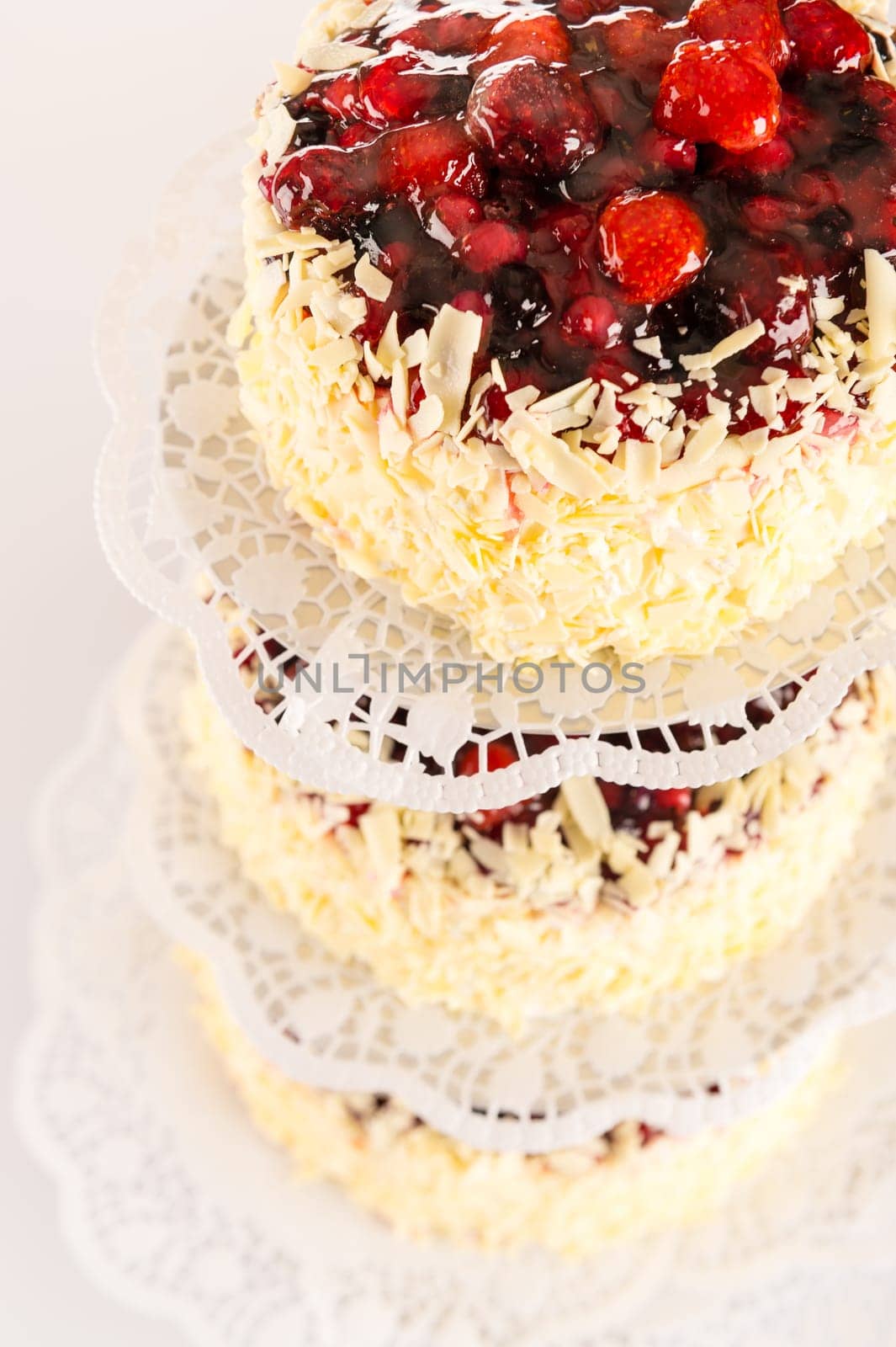 Stacked cake red berries and almonds white chocolate luxury decoration