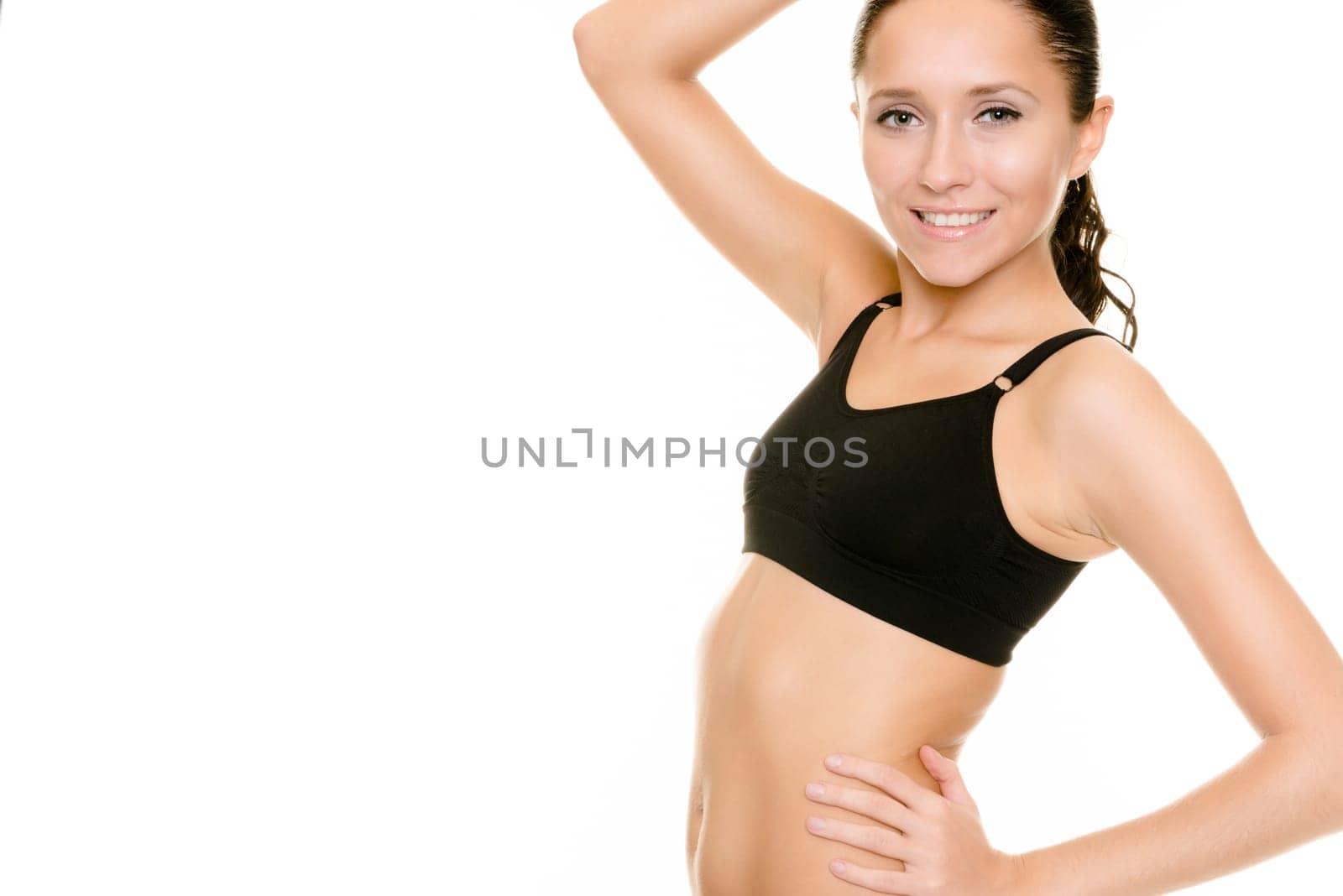 Young woman in sporty outfit against white background