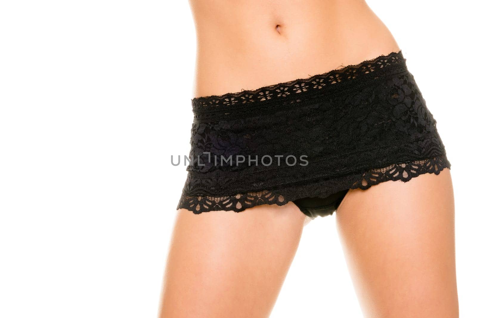 Young woman with black underwear against white background