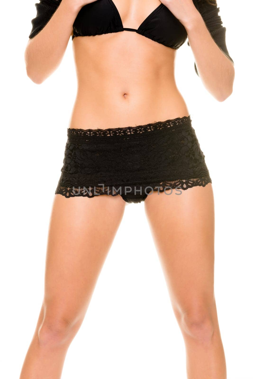 Young woman with black underwear against white background