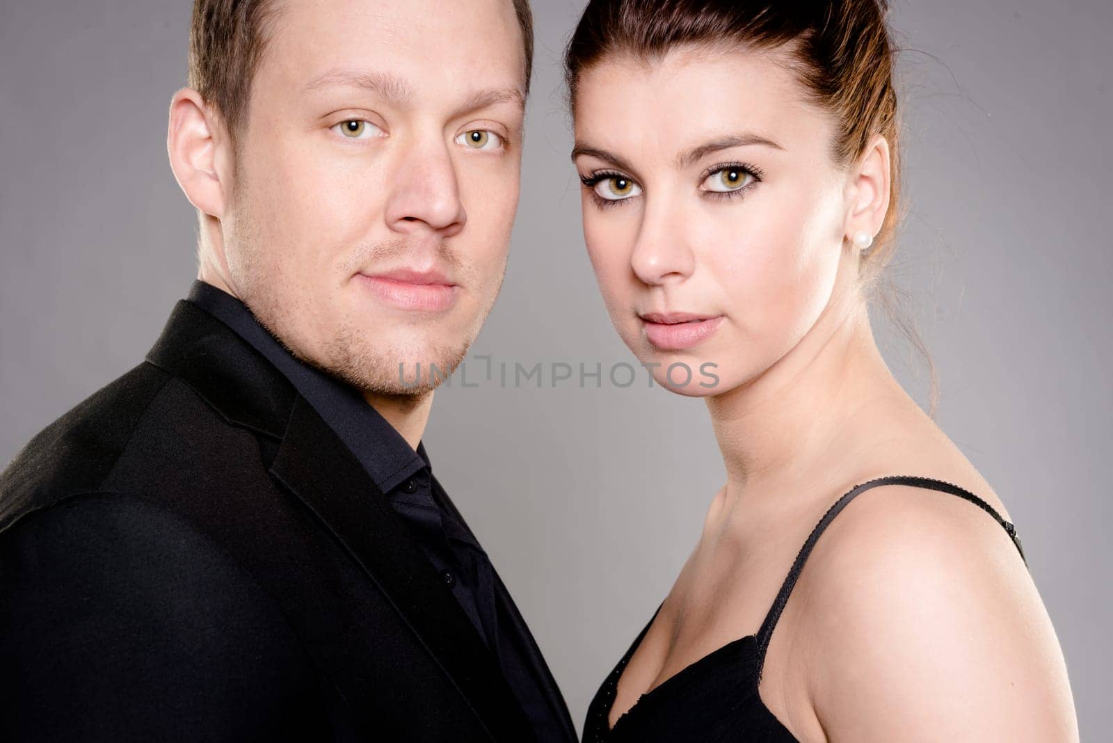 Studio shot of a young couple against a gray background