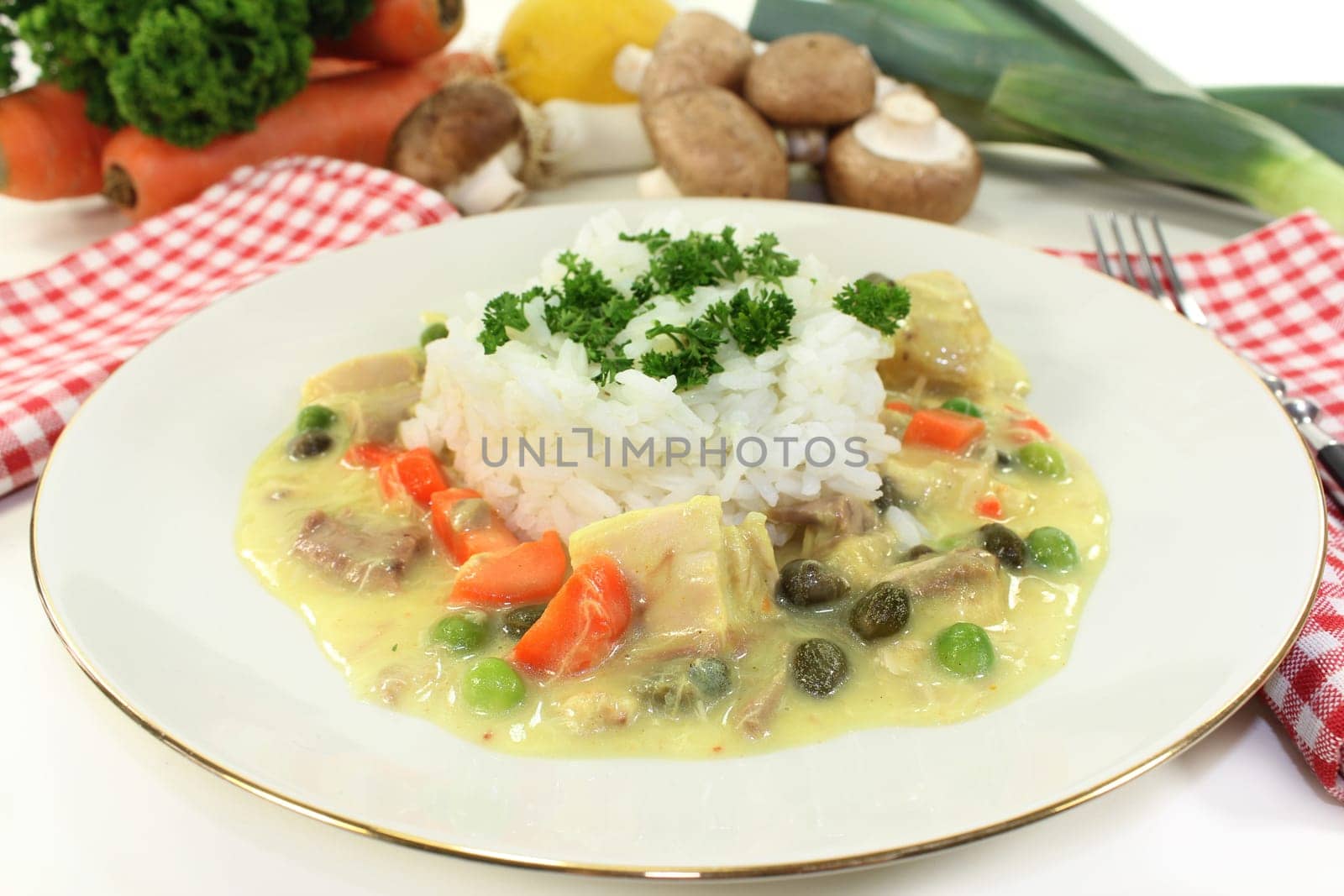a plate of rice and colorful chicken fricassee