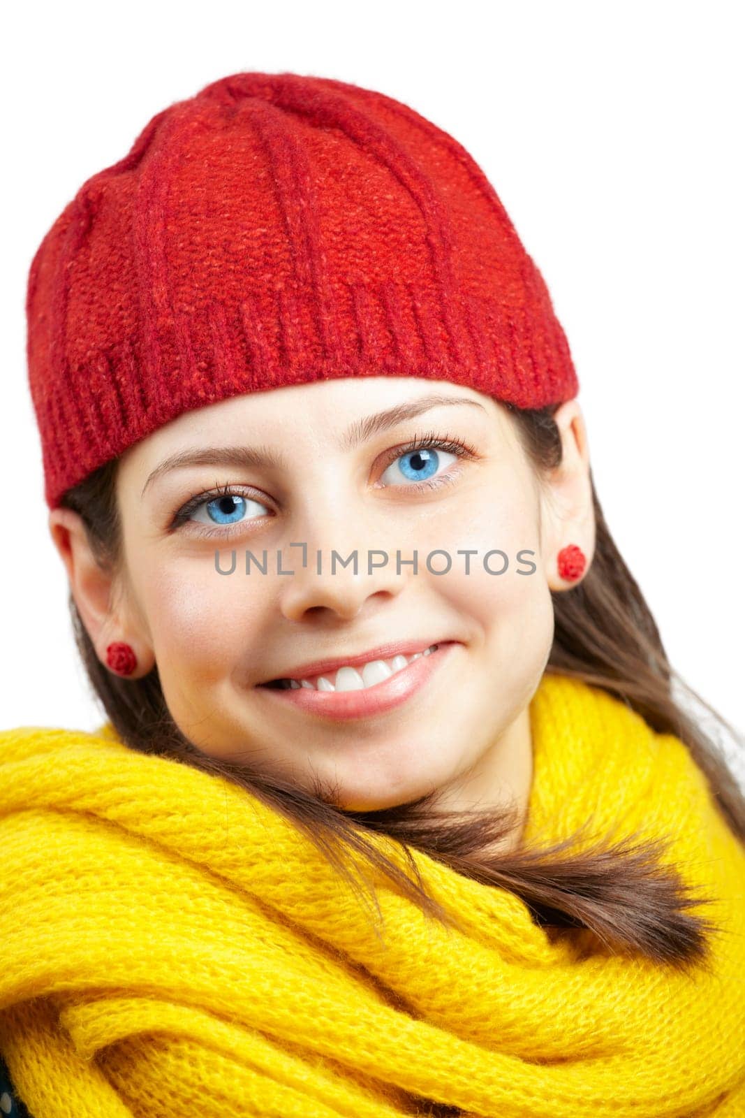Portrait of a beautiful young woman with yellow scarf and red hat over white background.