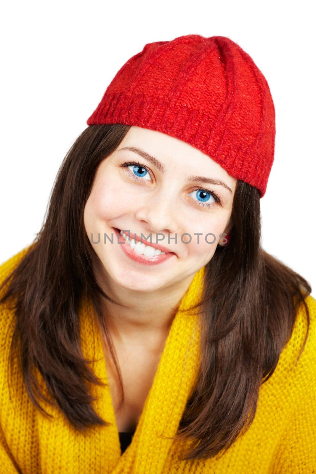 Portrait of a beautiful teenage girl with yellow scarf and red hat over white.